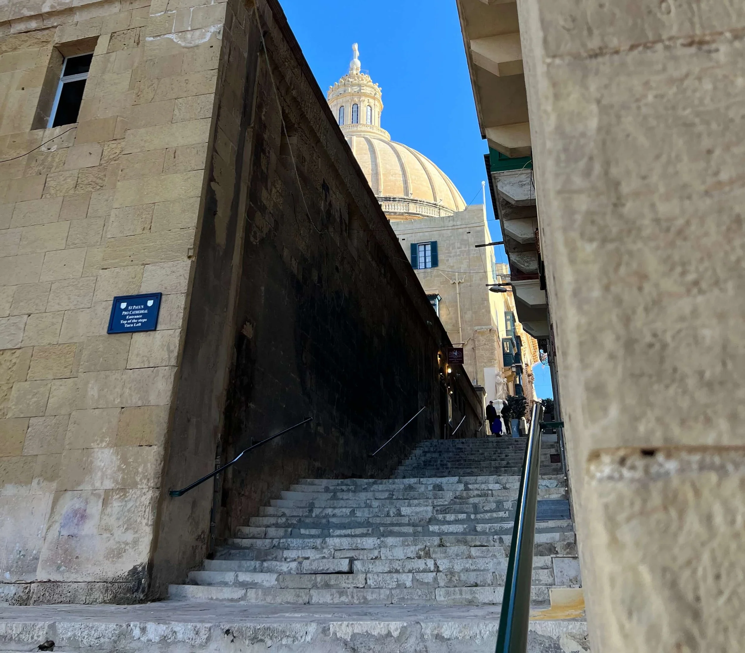 The iconic dome of the Basilica of Our Lady of Mount Carmel rising above the narrow streets of Valletta.
