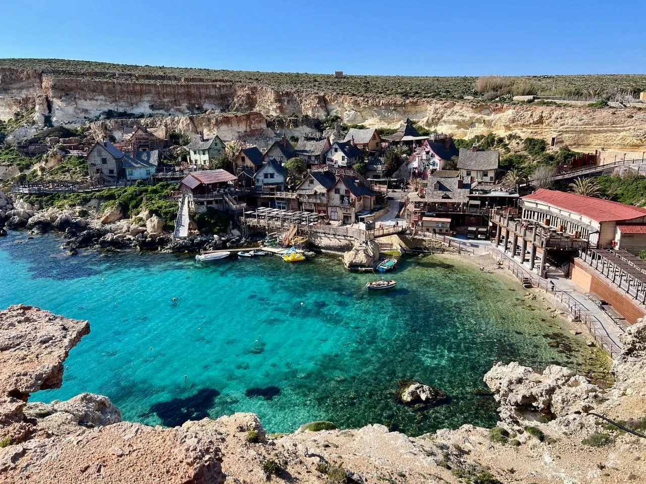Panoramic view of the colorful wooden Popeye Village film set tucked in Anchor Bay.