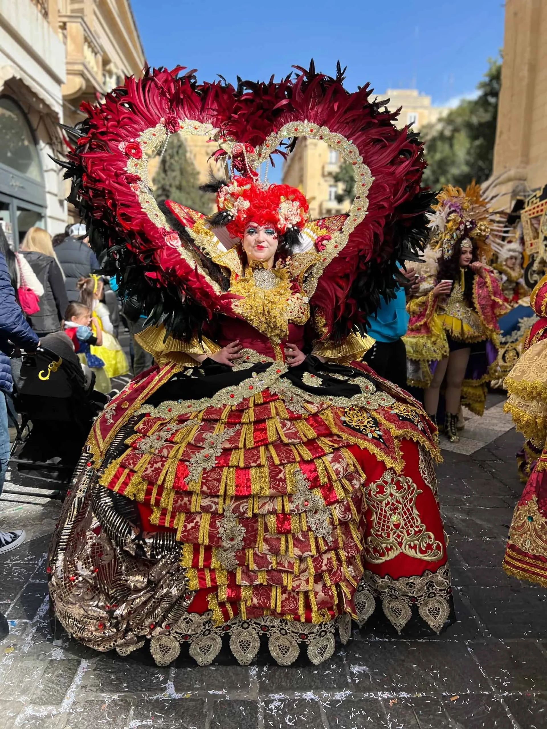Dancer in a heart-shaped red dress at Malta Carnival.
