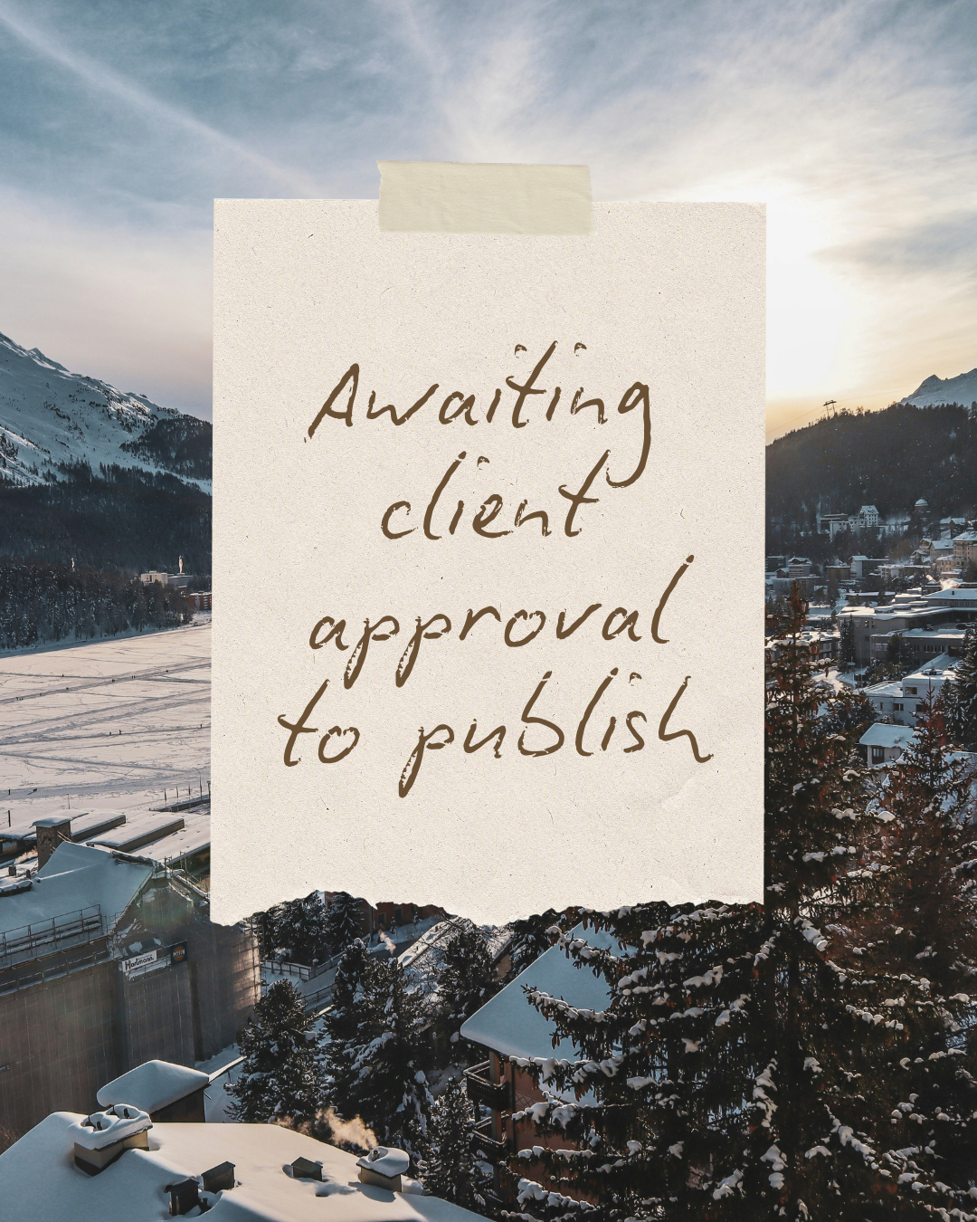 A snowy mountain town with buildings and trees covered in snow. A handwritten note taped to the image reads, "Waiting client approval to publish."