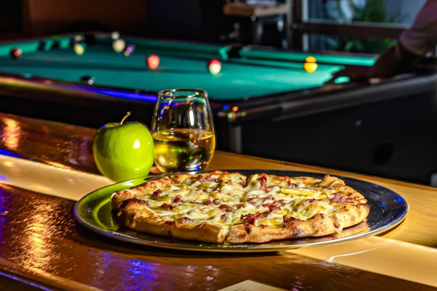 Stay warm at our place this weekend 🍕🎱🍏🍻🔥 Who thinks we&rsquo;ll see snow in the courtyard tomorrow??