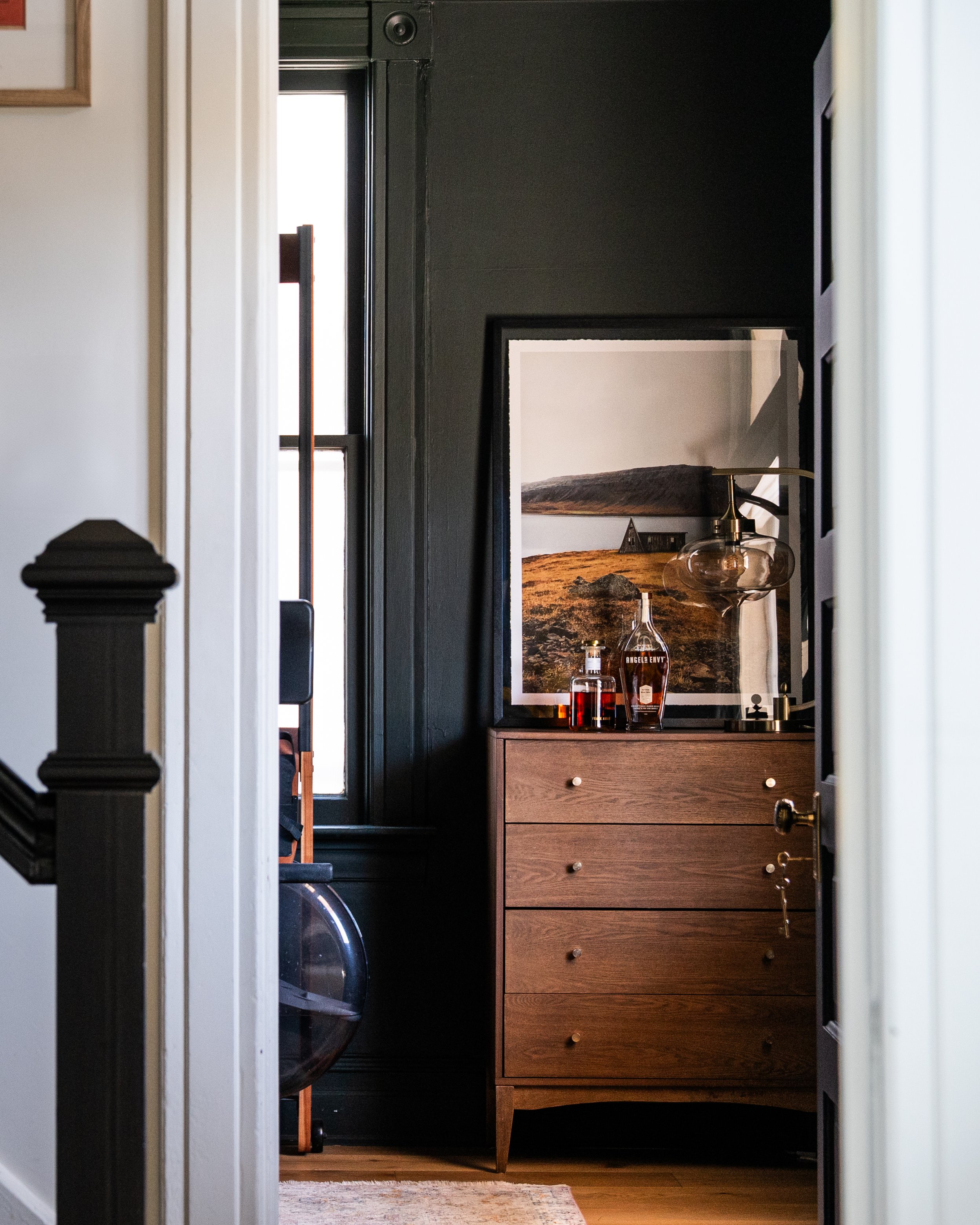 interior design of a dark moody office with art from faroe islands.