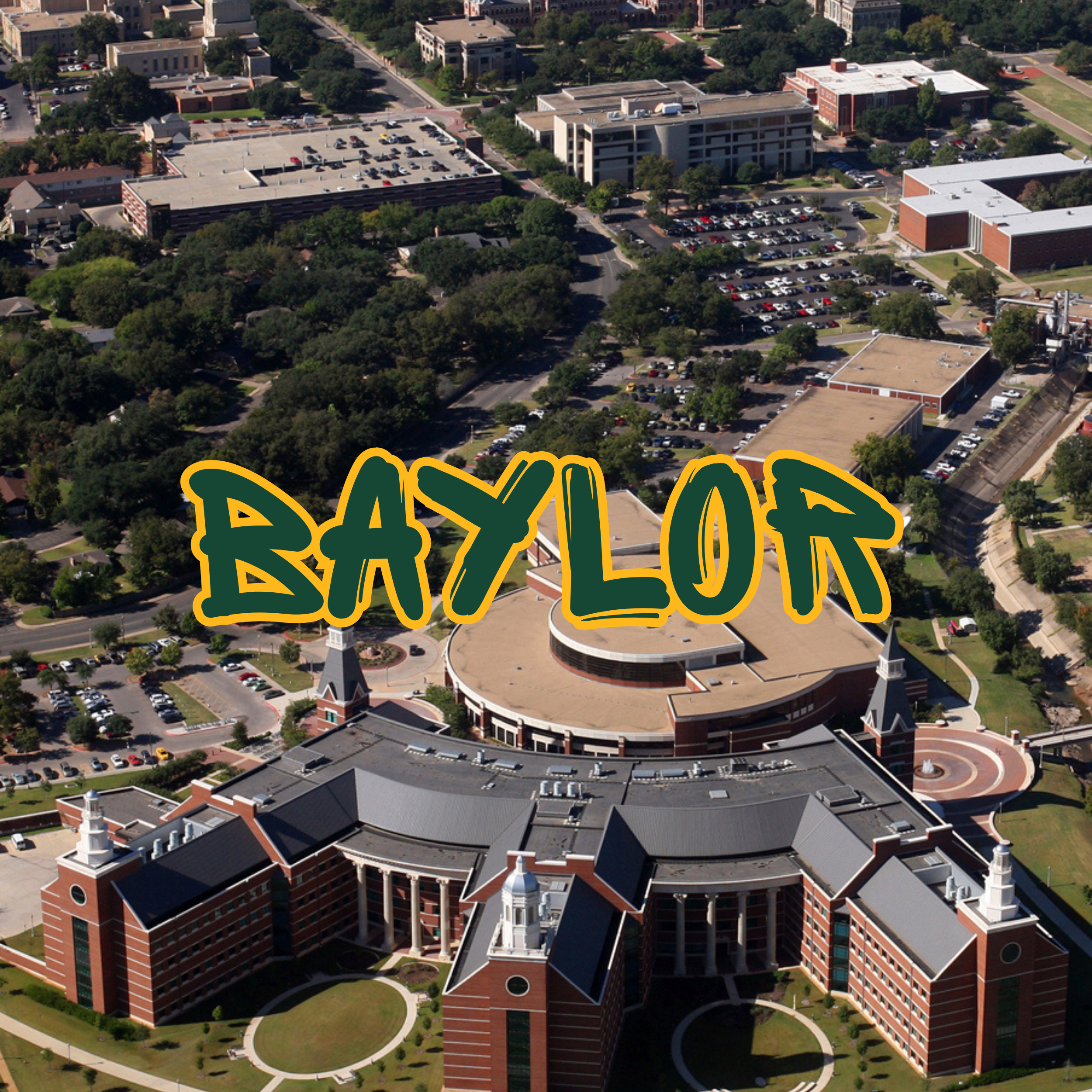 Aerial view of a college campus with multiple buildings, parking lots, and green areas. The main building has a unique circular and rectangular architecture with white spires on top. Surrounding it are other academic buildings and lots of trees.