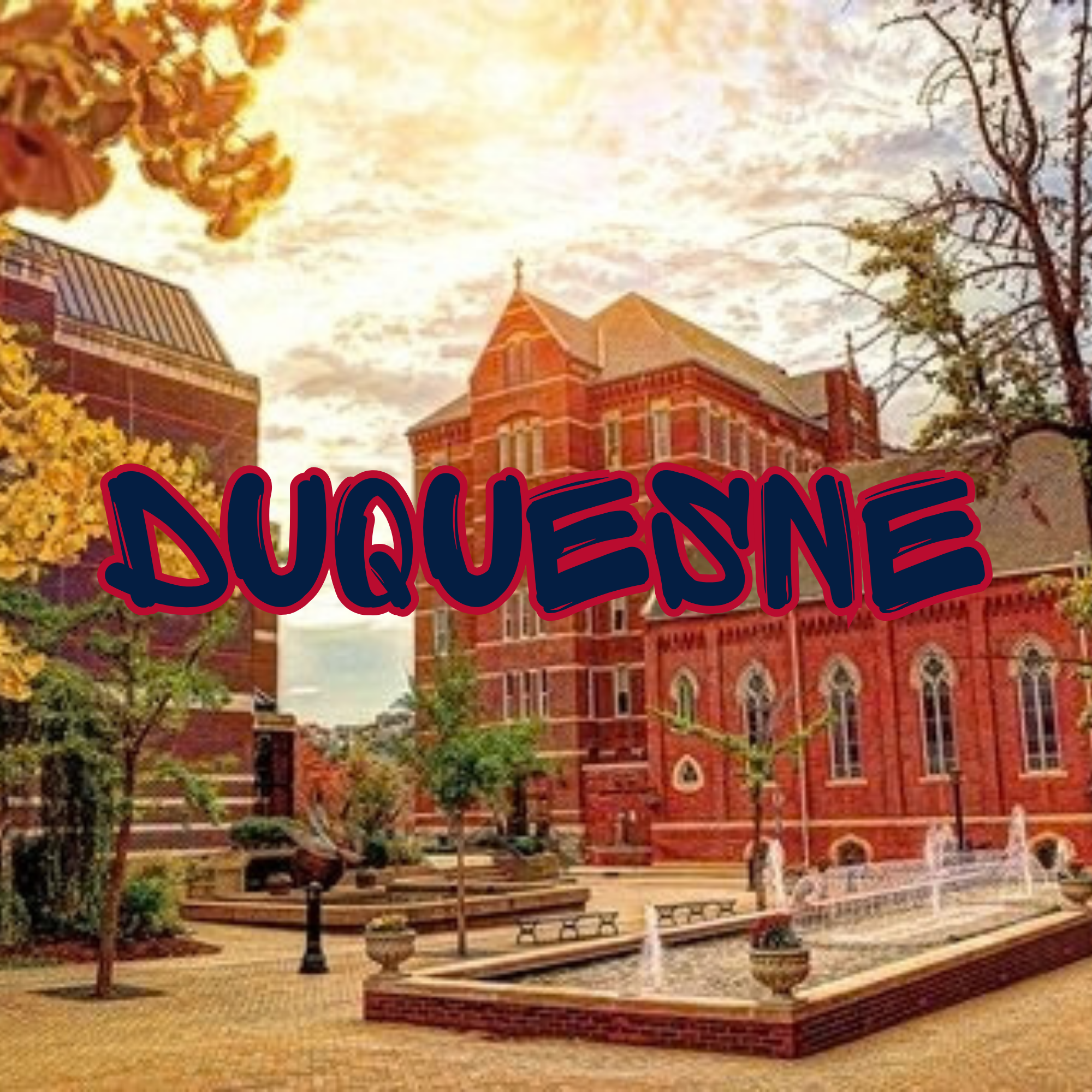 A historic red brick building with a clock tower, surrounded by trees with autumn foliage, with a bench in the foreground and a brick paved area.