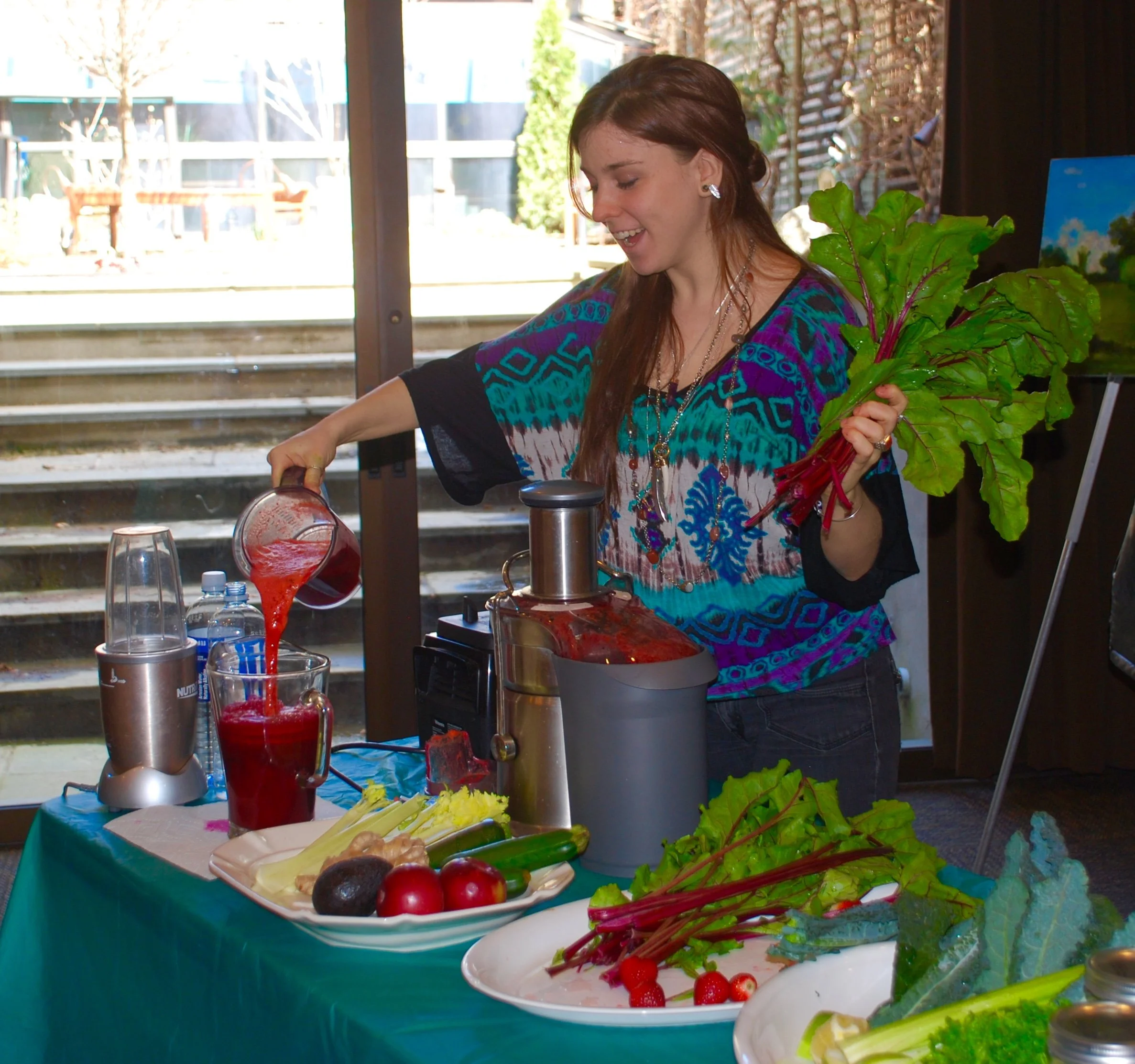 Juicing station with woman pouring freshly made juice