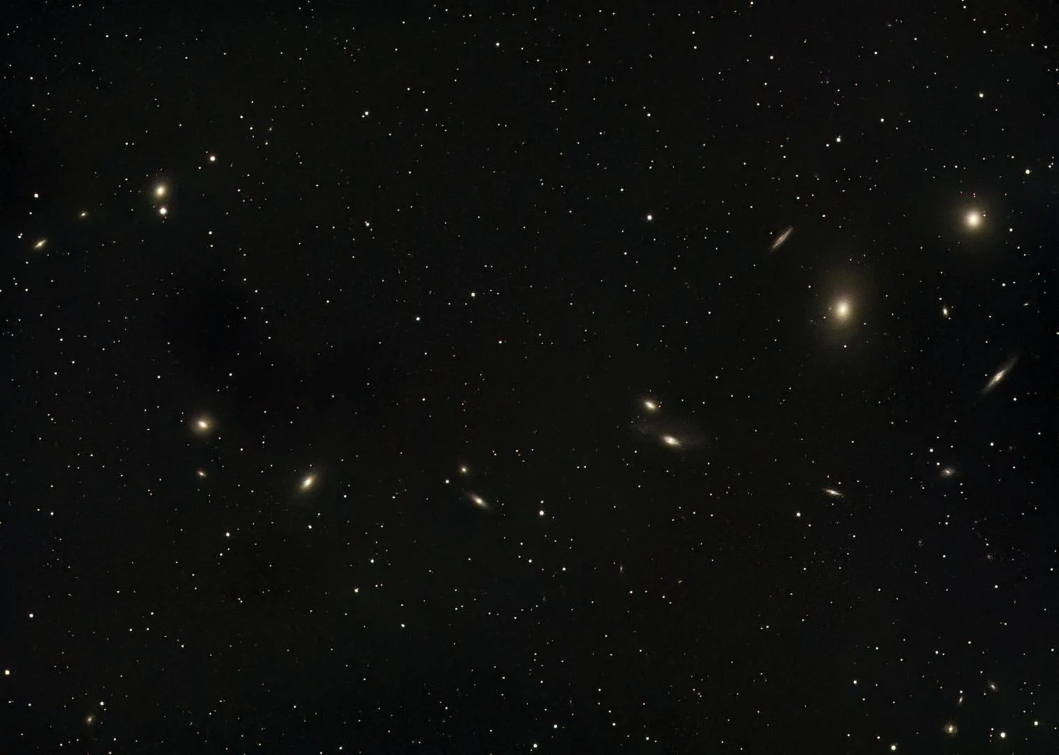 One of the largest structures you can photograph is Markarian's Chain in Virgo. A group of galaxies moving together. 