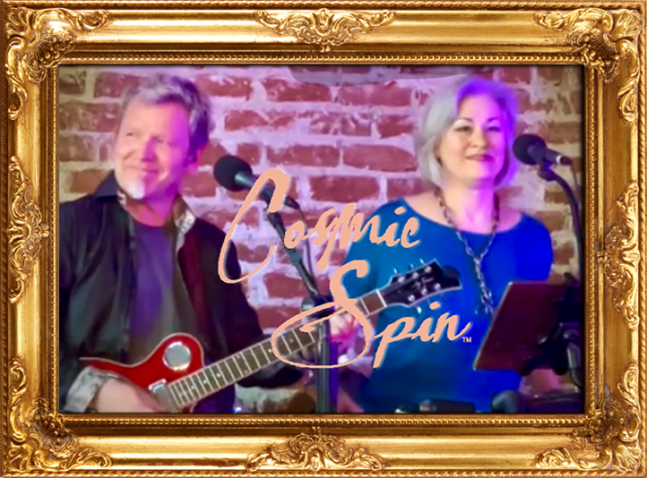 Two performers, Robert Cassard playing a guitar and Bara Waters singing into microphones, in front of a brick wall, framed in an ornate gold picture frame, with the words "Cosmic Spin" overlaid.