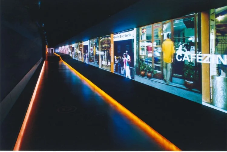 grande galeria:
Tela de projeção de 115m com filmes independentes projetados simultaneamente.
A iluminação apenas baliza o percurso, recriando a ideia de uma linha de trem.