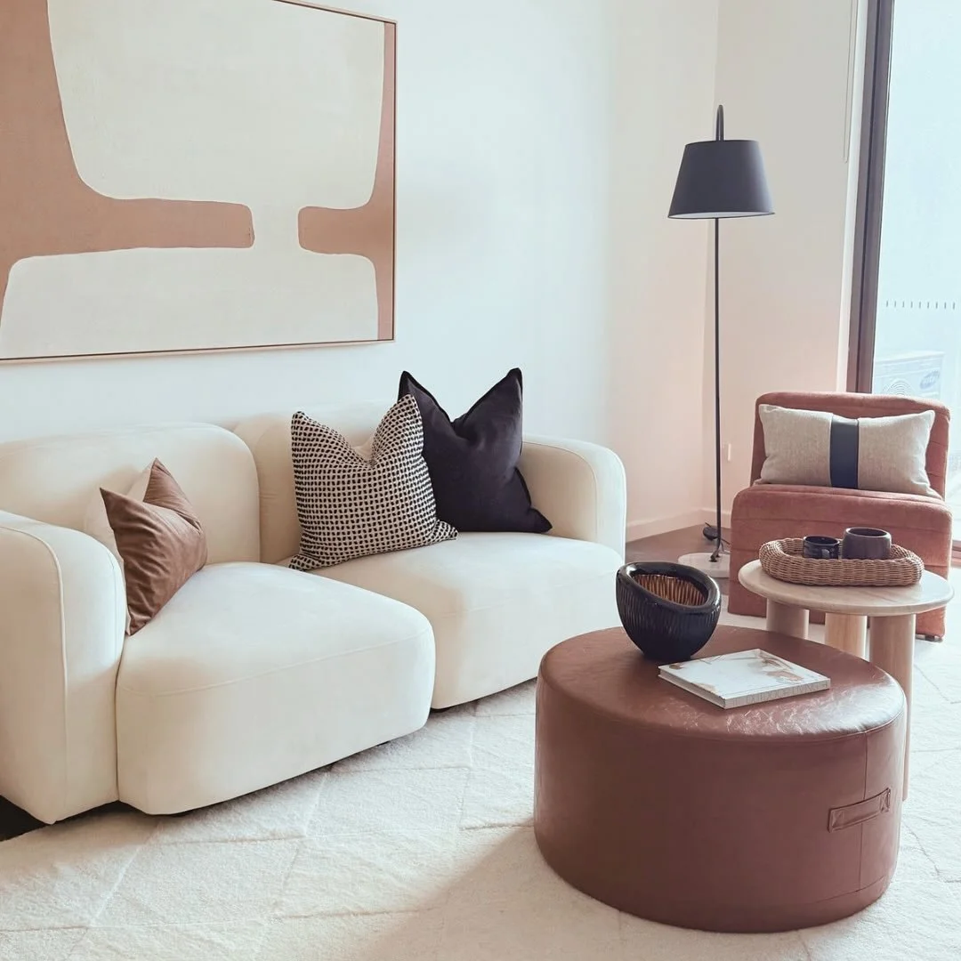 This space is a tonal balance. 🤎 The creamy curves of the sofa soften the room, while structured accents in chocolate, black and rust add grounding contrast.  Sometimes the most inviting rooms are the ones that whisper .  #interiorstyling #sydneypro