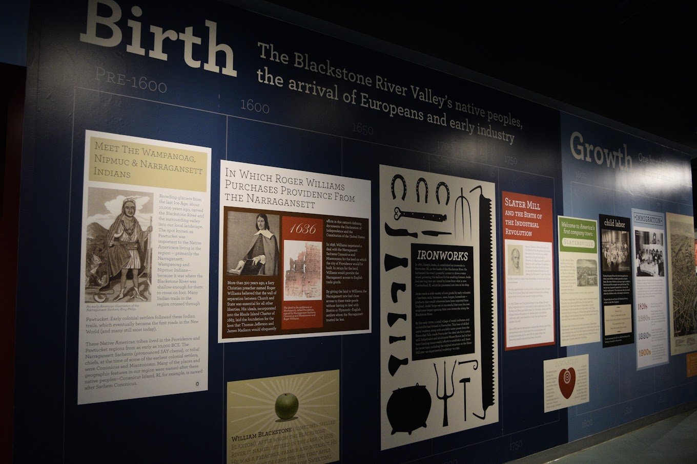 Exhibit wall discussing the Blackstone River Valley's history, highlighting native peoples, European arrival, and industrial development. Text covers tribes, Roger Williams, ironworks, Slater Mill, child labor, and immigration. Images of historical f