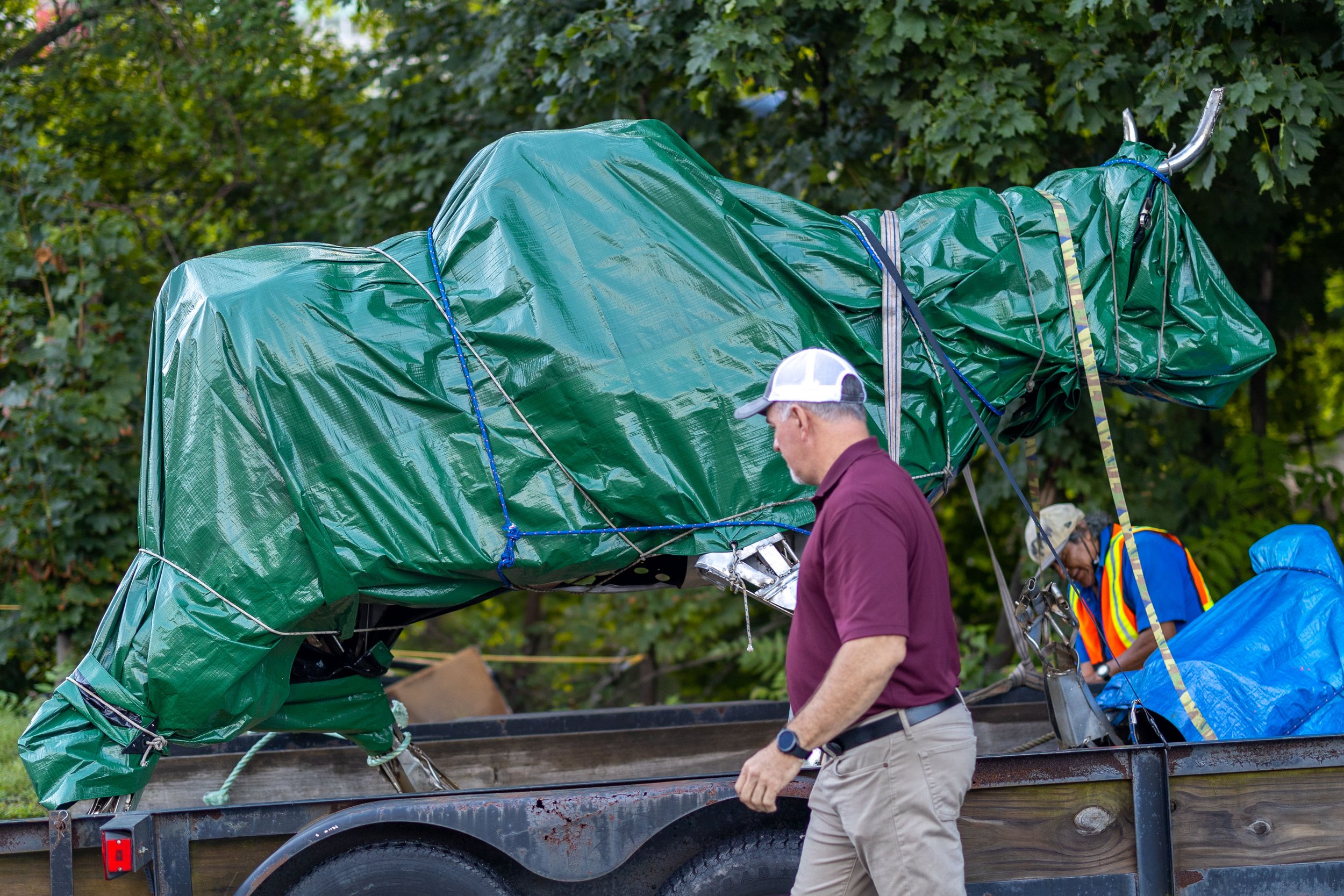 Statue covered in green tarp