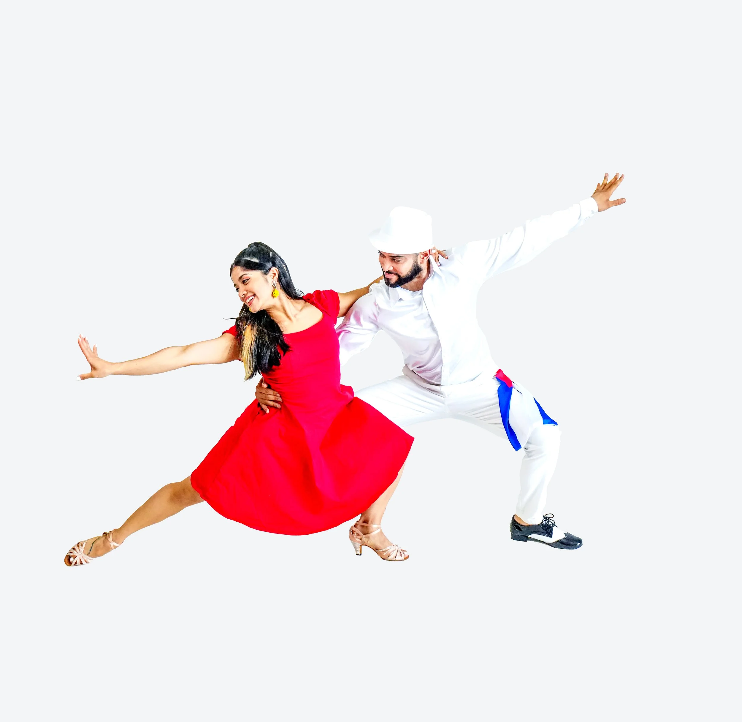 A dancing couple, woman in a red dress and man in white with a blue accent, mid-dance with arms outstretched against a plain white background.