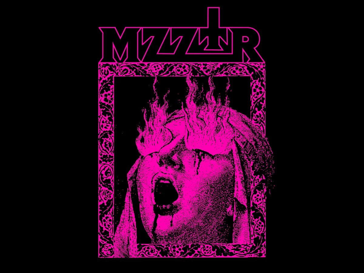 Pre Order our new MZZTR shirt, depicting a screaming face of a woman with pink flames coming from her eyes, surrounded by an ornate border, all in black and pink colors.