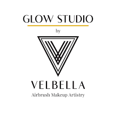Logo for Glow Studio by Velbella Airbrush Makeup Artistry with a stylized triangle design.