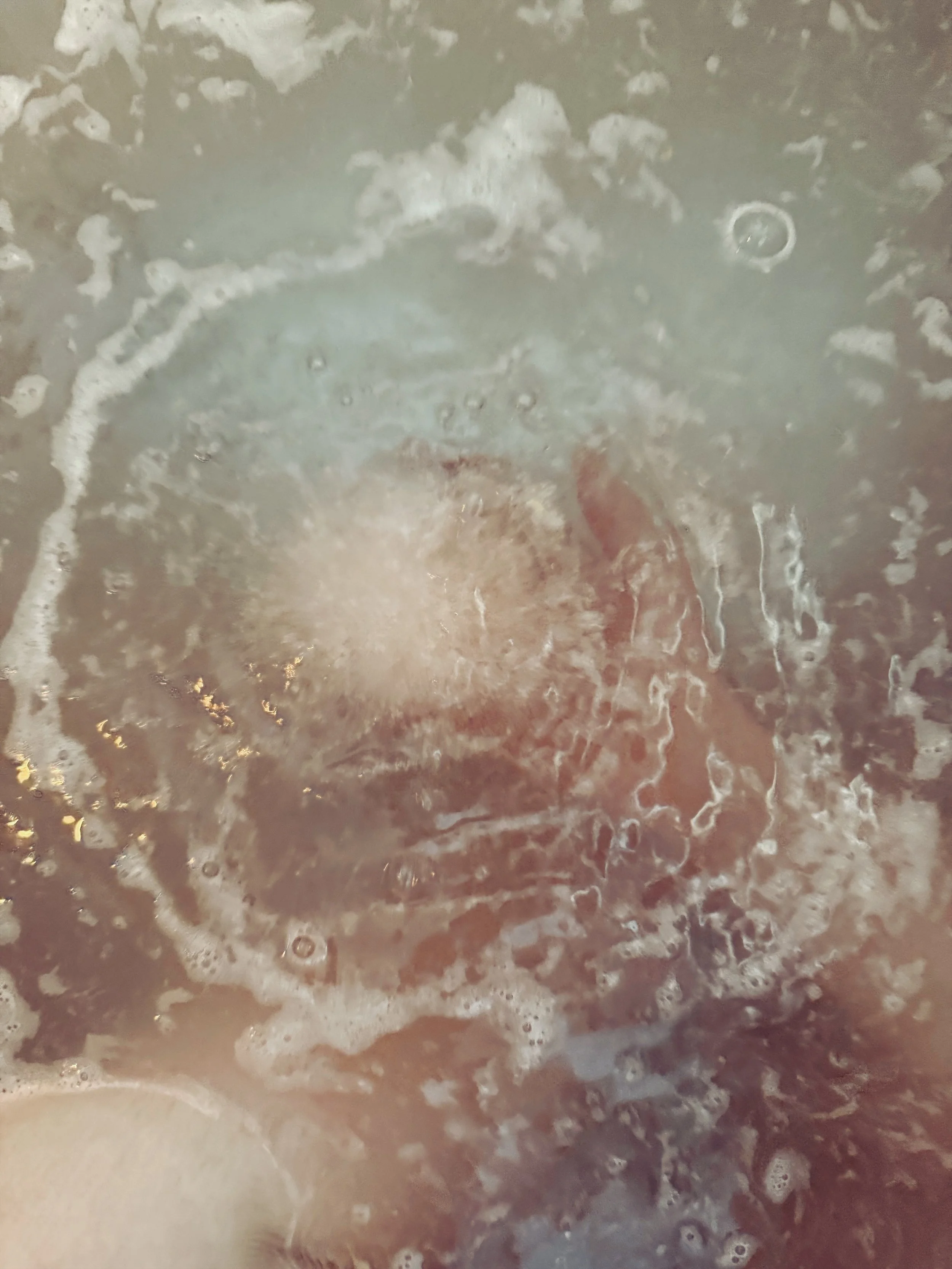 Close-up of soapy water with bubbles and foam. Fizzy bath bombs