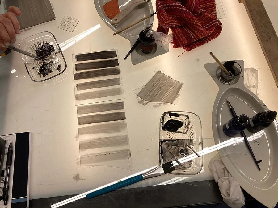 light table used for painting stained glass with brushes and paints of various opacity