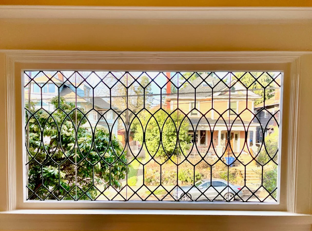 leaded glass window in portland building with diamonds, circles and clear glass