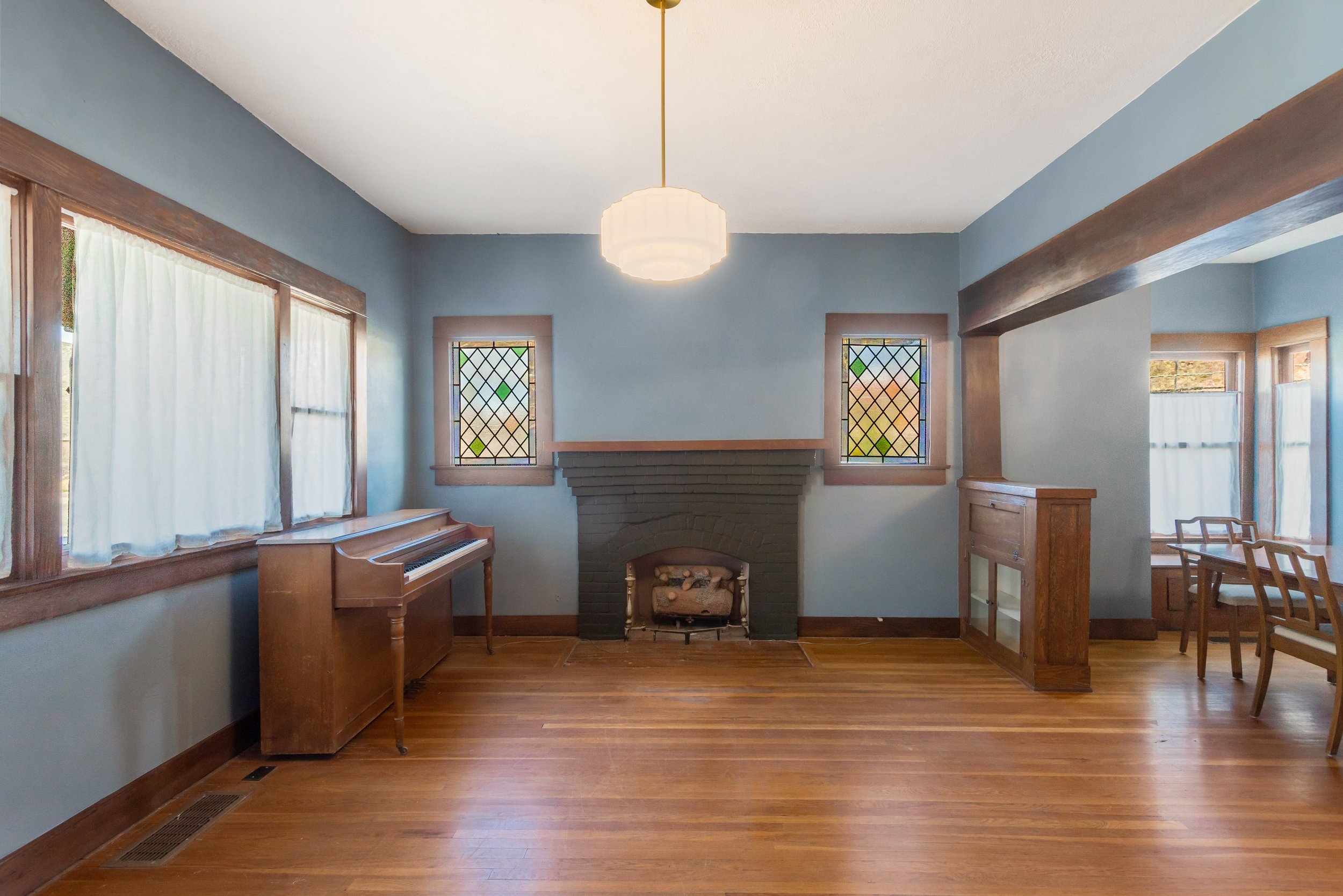 pair of stained glass windows flanking a fireplace