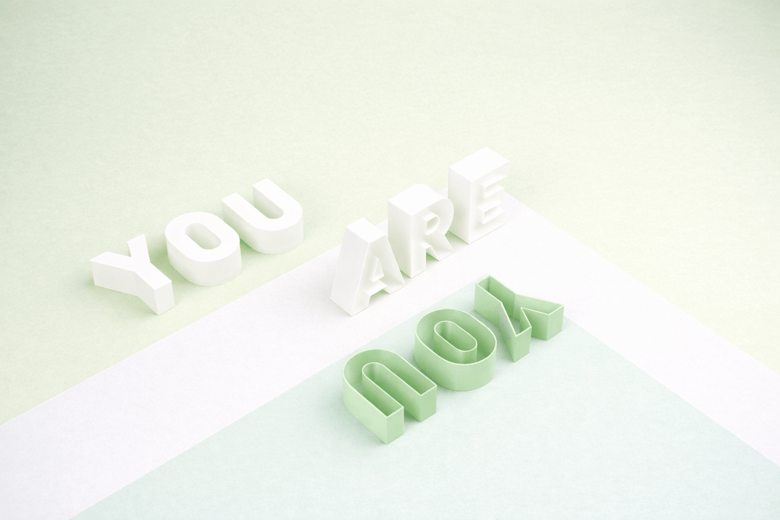 White and green 3D letters spelling 'You are' and 'love' on a pastel background.