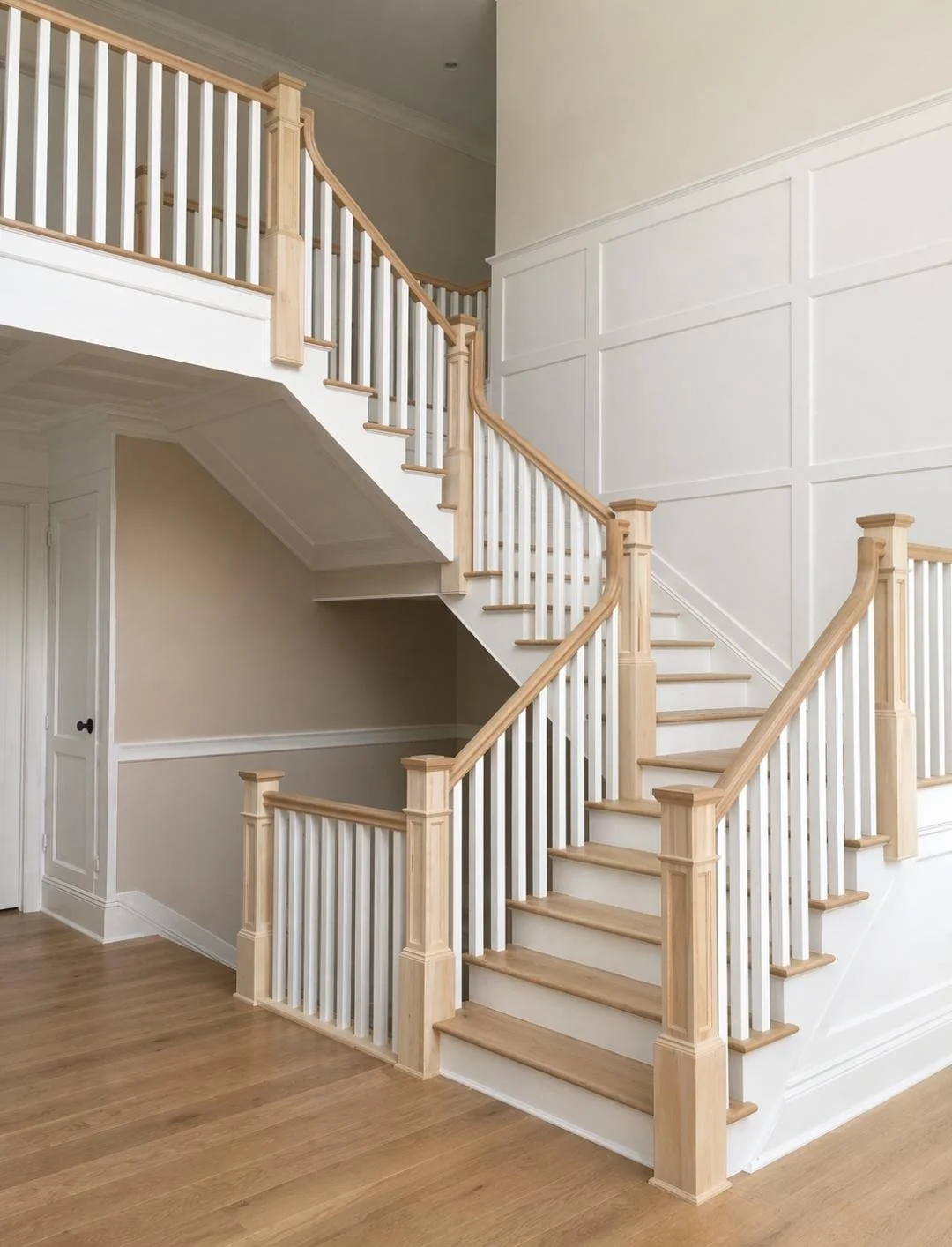 Photo of a wooden staircase with white spindles and light wood handrails inside a home.