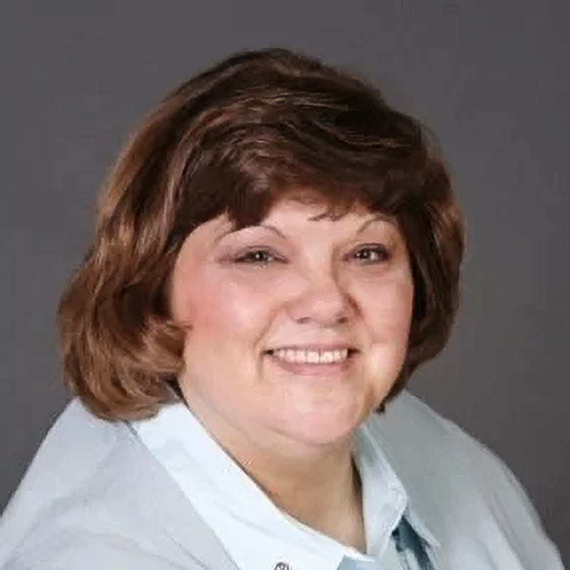 A woman with dark hair smiling
