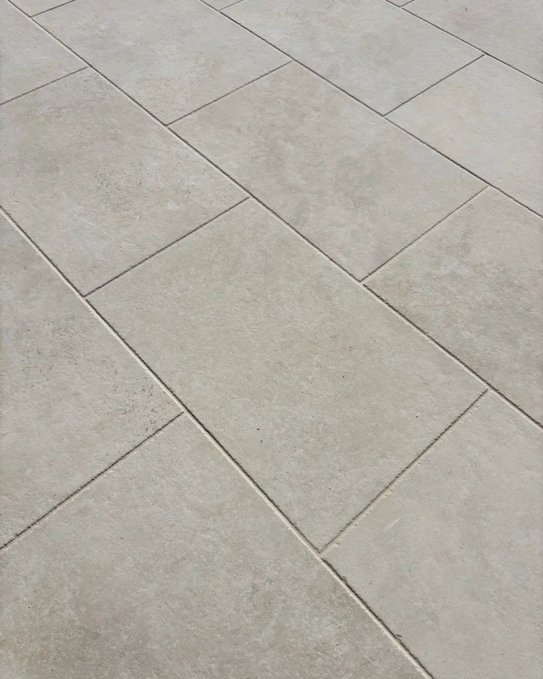 How we used it.

Using the same tile internally and externally is what makes this one work. 

The Jerusalem Stone Avorio has enough movement and texture to feel like natural stone, while still being consistent enough to run across large areas without