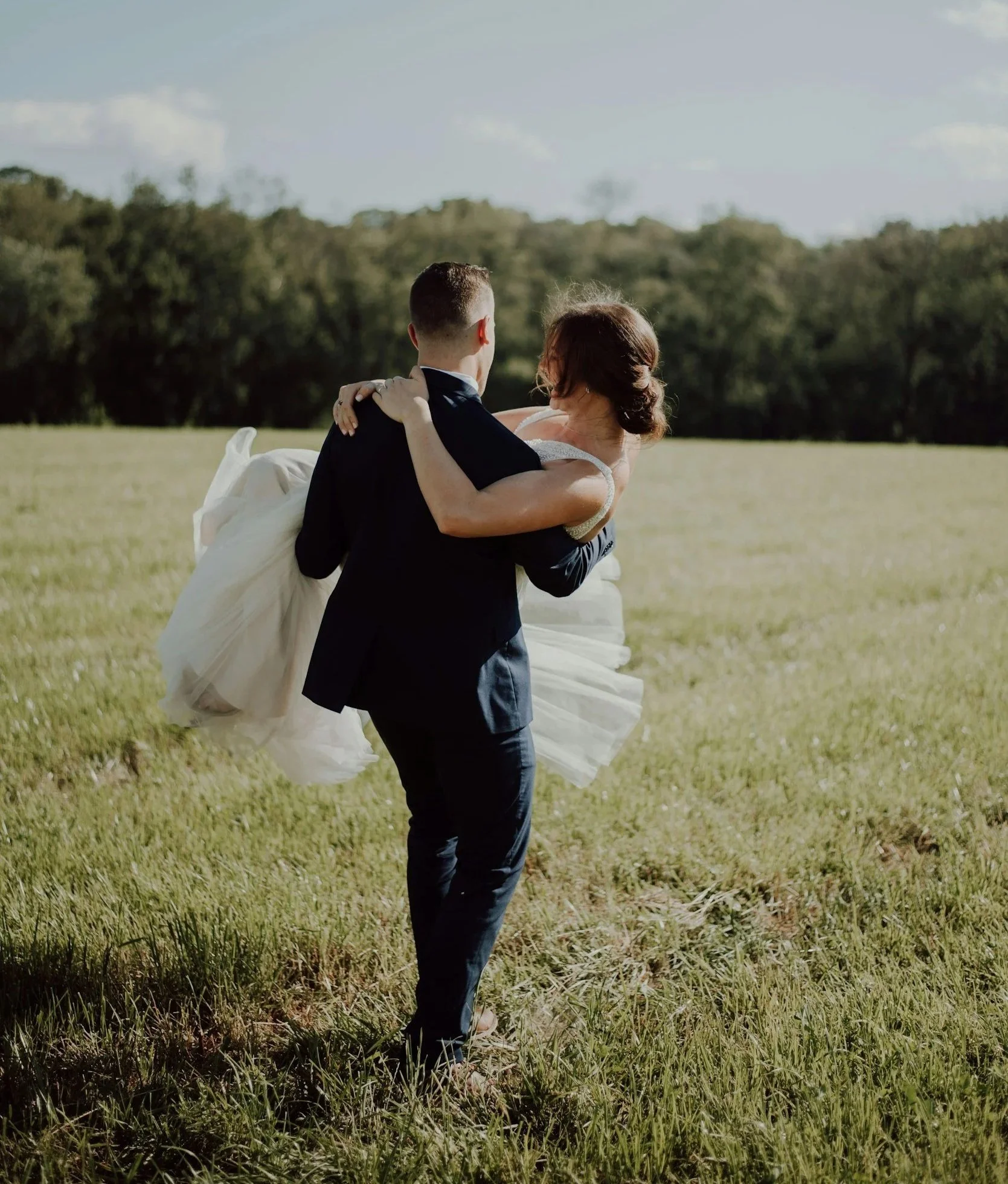 Wisconsin wedding couple walking through field