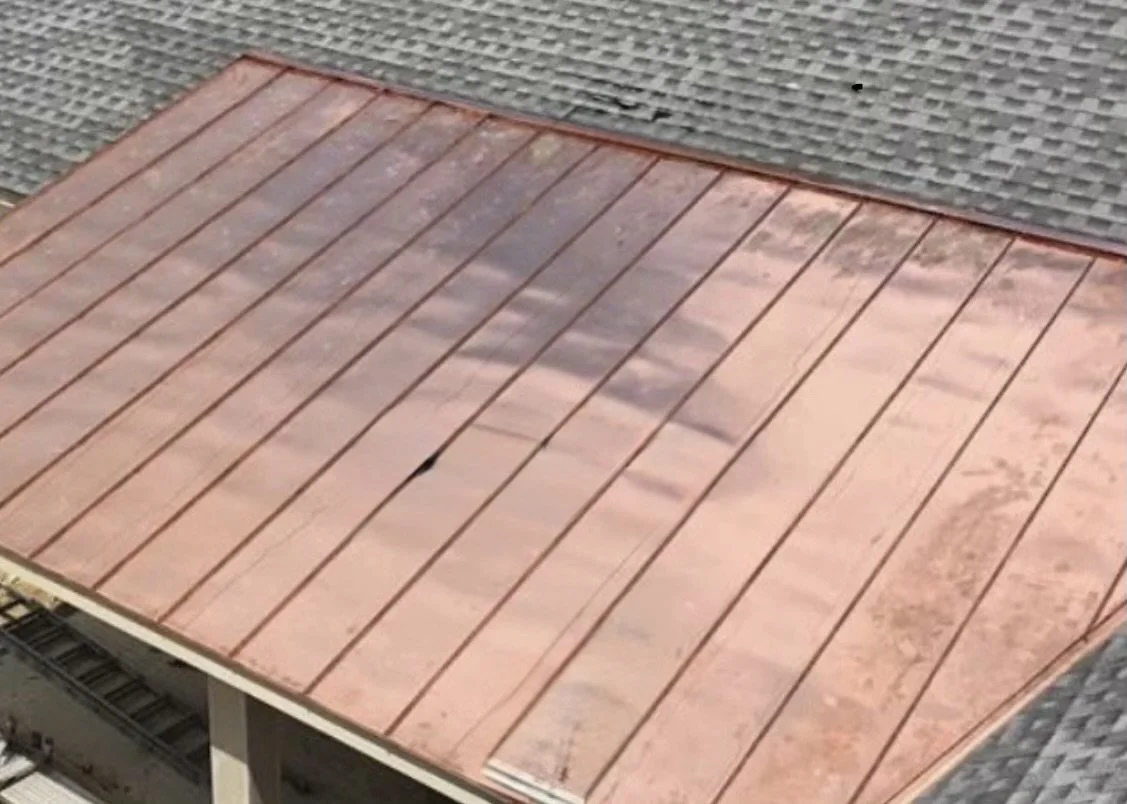 Slate roof with a copper standing seam roof