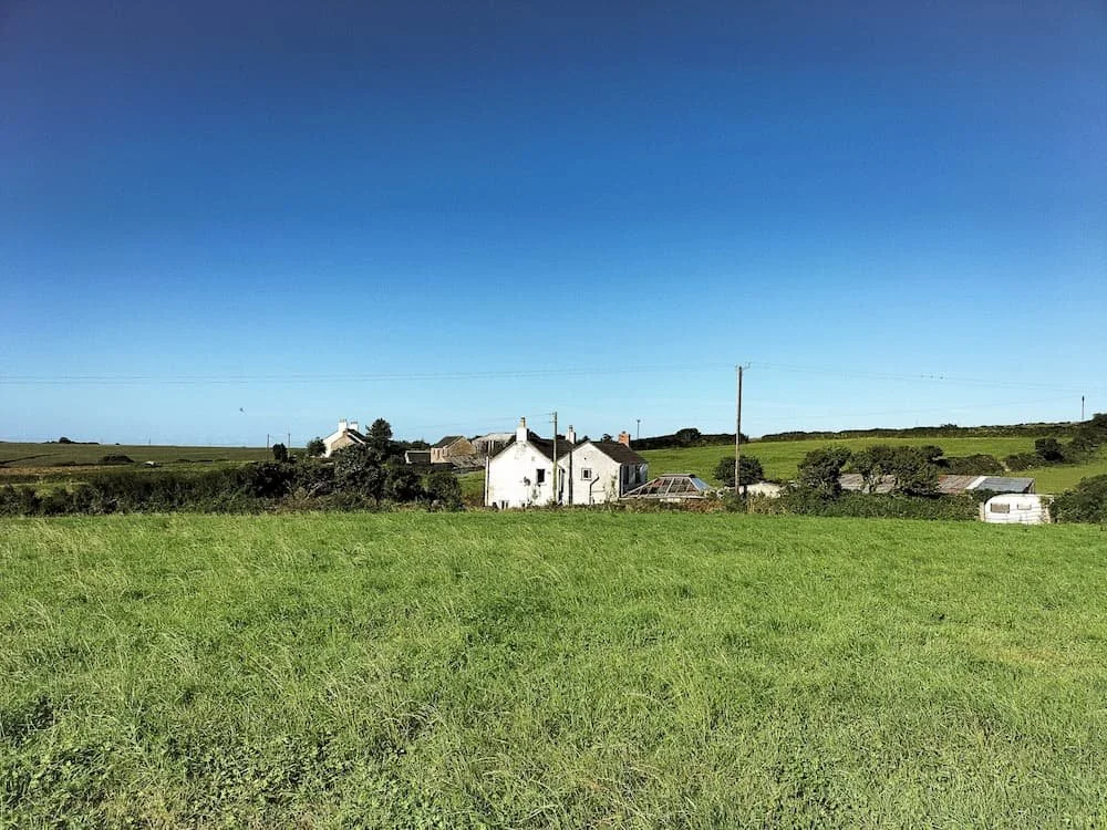 Exterior of Trengrove Cottage before renovation in Falmouth from afar