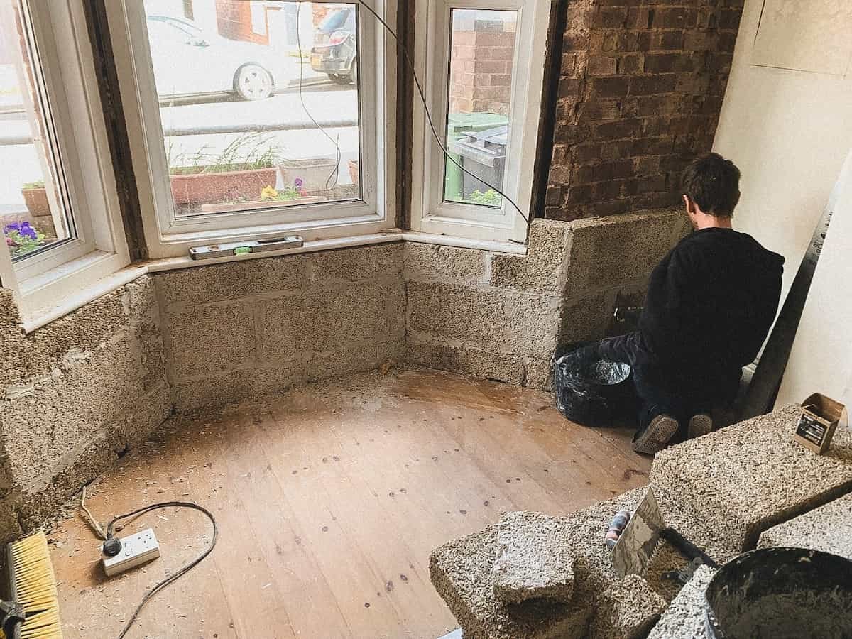The slabs being placed on top of the hemp block insulation in place around the windows of the house on Woodah Road in Exeter, Devon
