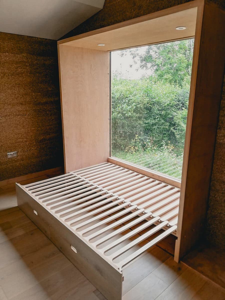 The window seat extended into a bed in the garden office/bedroom in Marlow, Buckinghshire