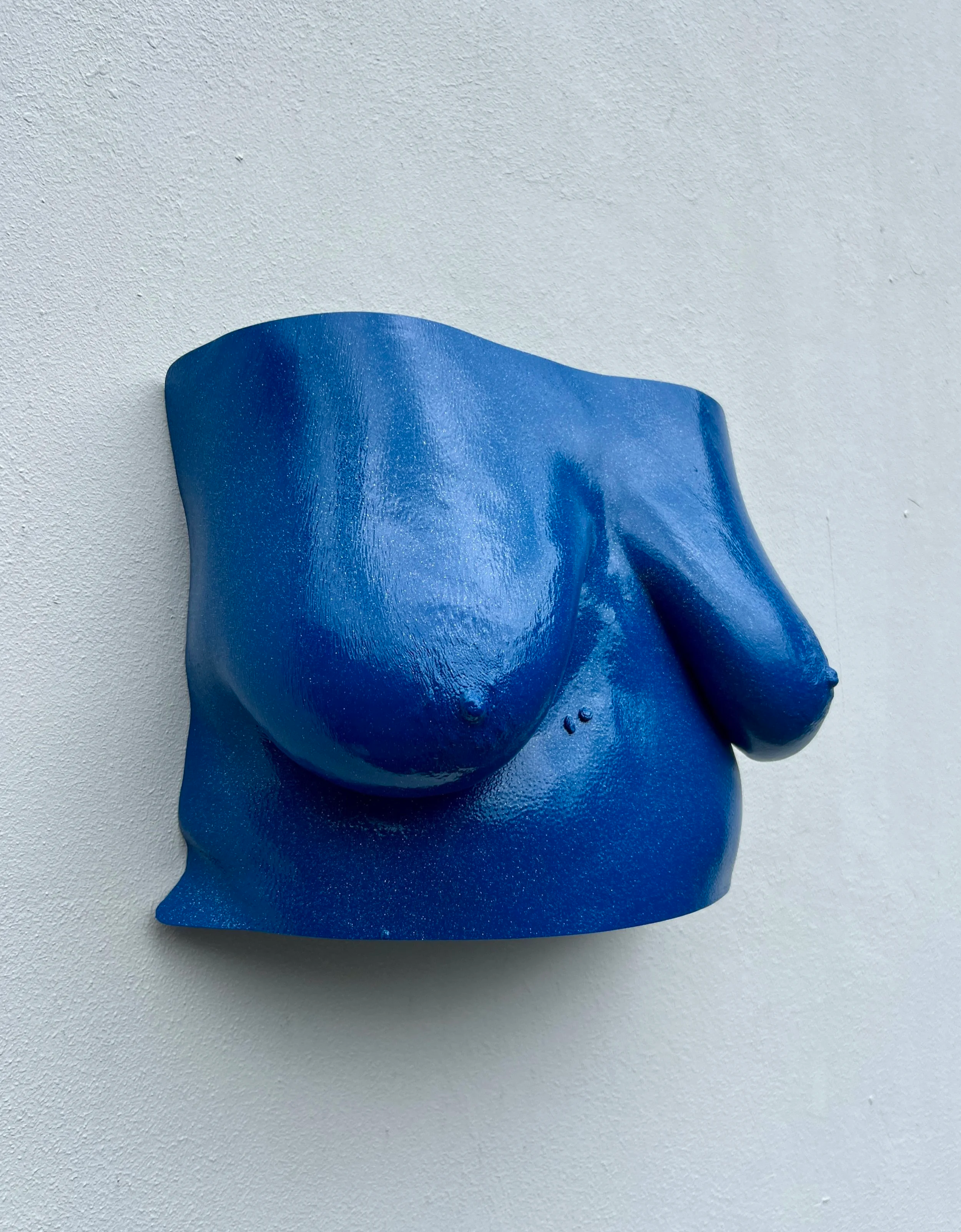 Donkerblauw bodycasting borstkastsculptuur met borsten, handgemaakt van hars met glitters en glanzende afwerking, kunstwerk van Venus in Vorm, zichtbaar zijn twee moedervlekjes op de buik en rolletjes aan de zijkant.