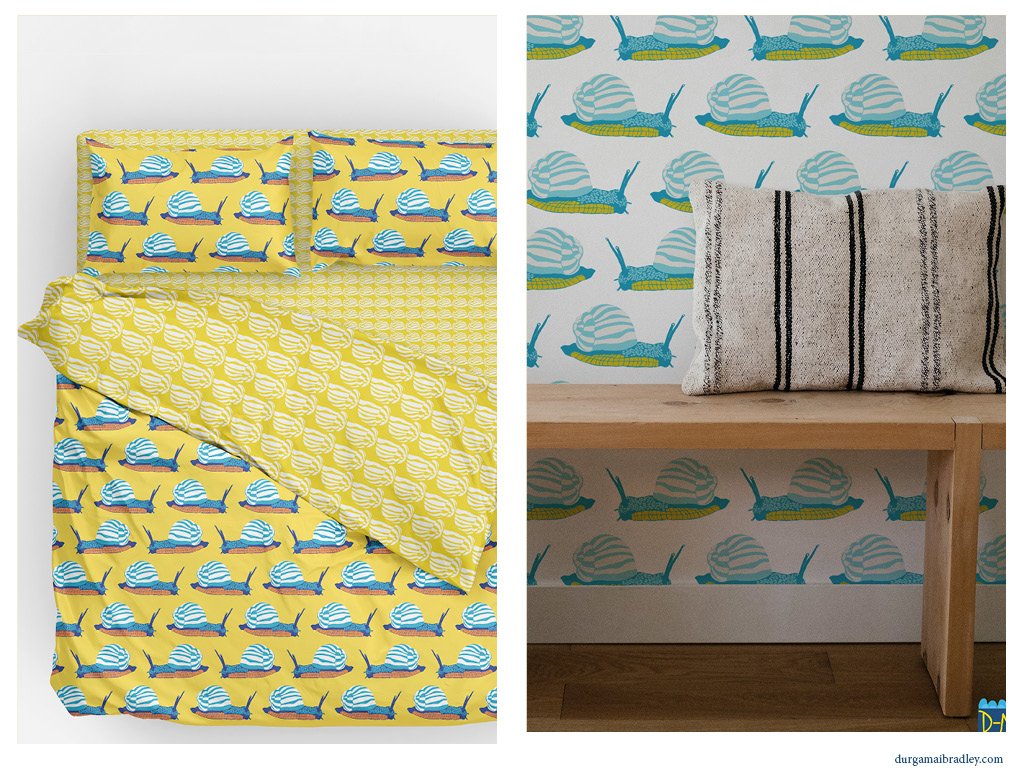 Left side shows a bed with yellow bedding and pillows with a pattern of blue snails, right side shows a wall with snail-patterned wallpaper and a wooden table with a towel on top.