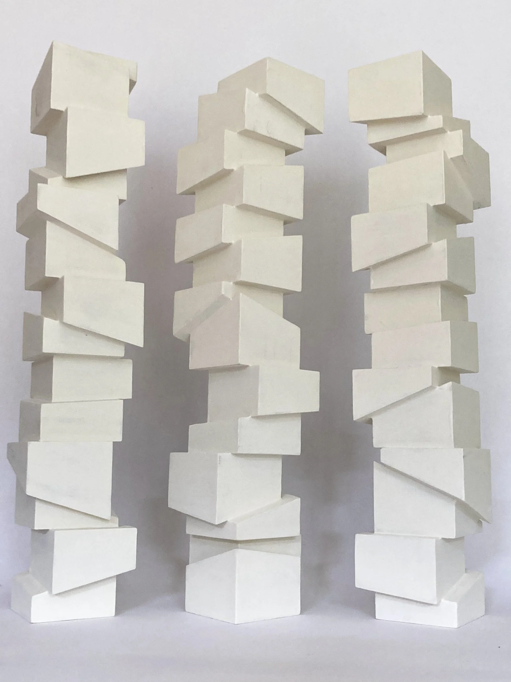 Slip Sculpture.  Vertical sculptures created by stacking cubes cut at angles.