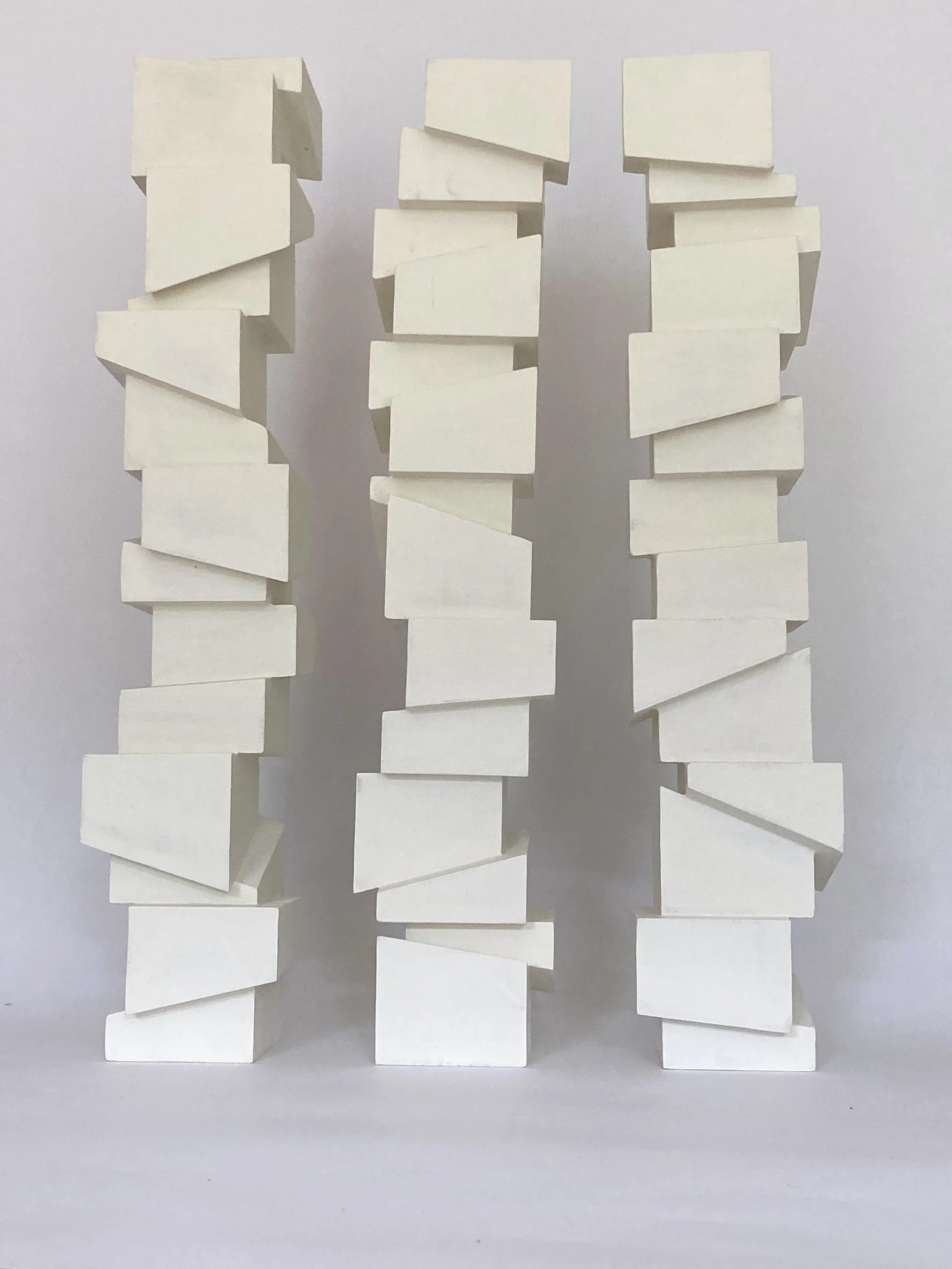 Slip Sculpture.  Vertical sculptures created by stacking cubes cut at angles.