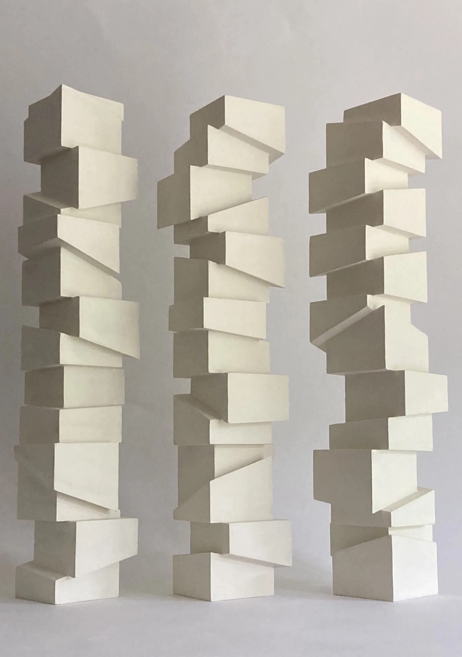 Slip Sculpture.  Vertical sculptures created by stacking cubes cut at angles.