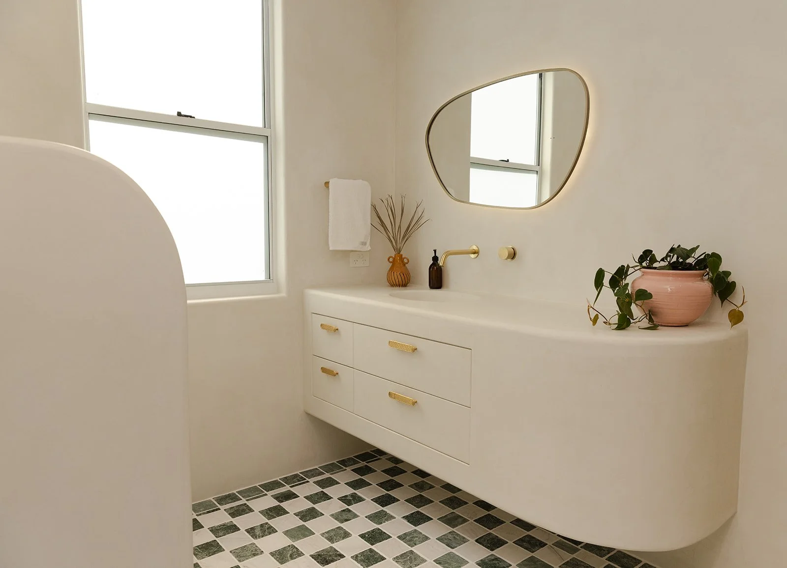 the-riad-agnes-water-bathroom-soft-curves-gold-fixtures.jpg