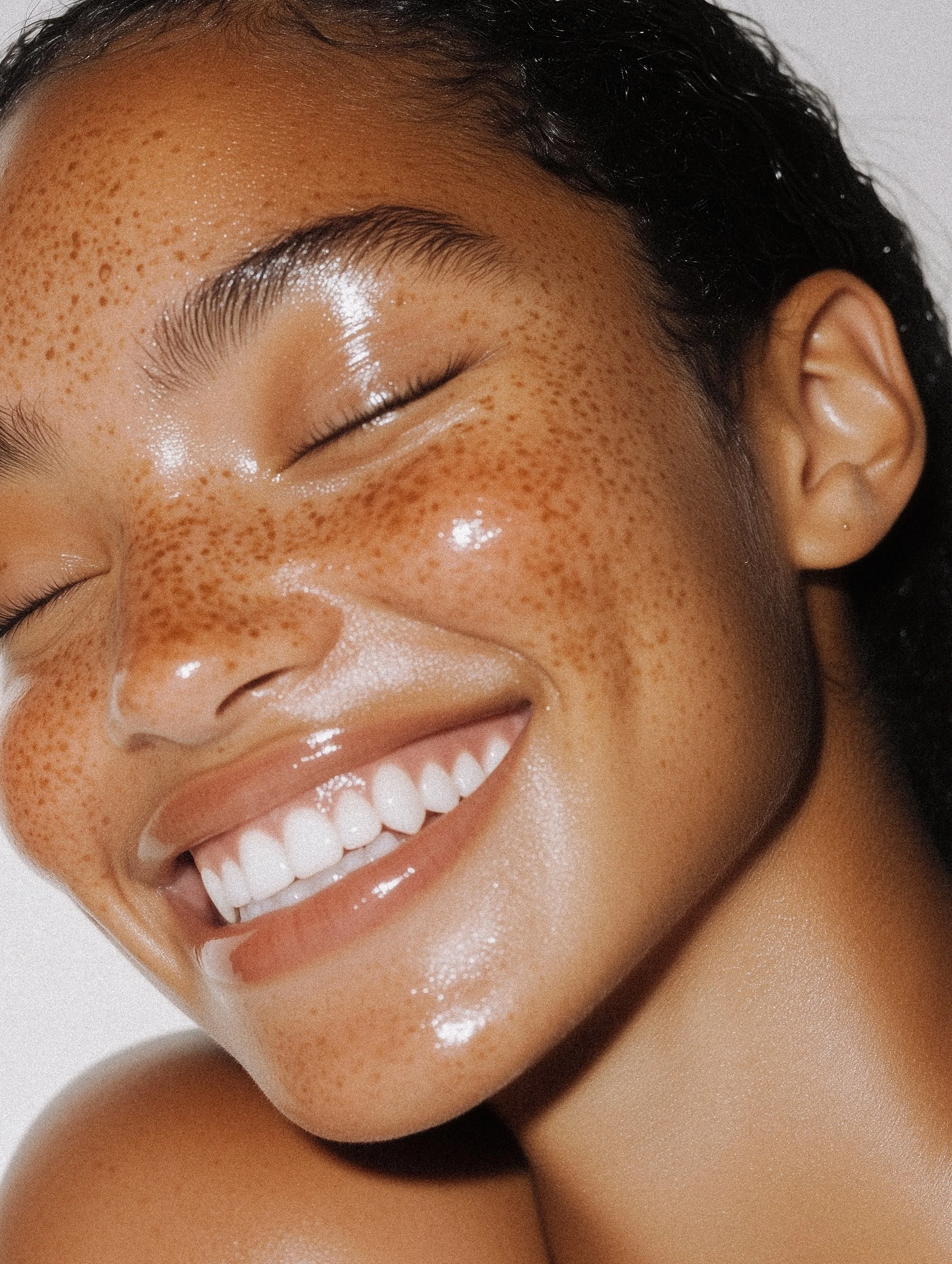a woman smiling with clear skin 