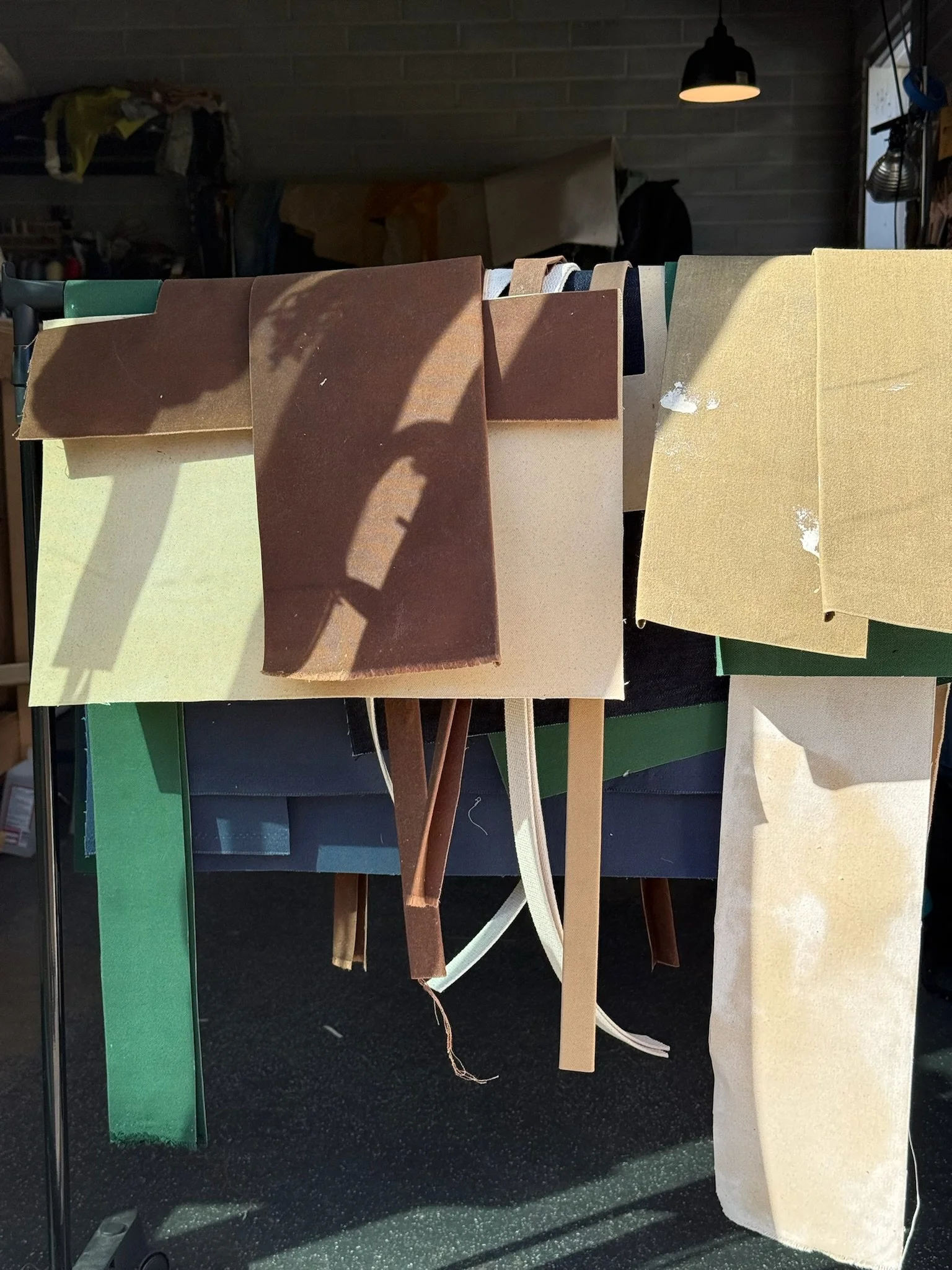 Waxed canvas pieces and strips for straps, waiting to be used.