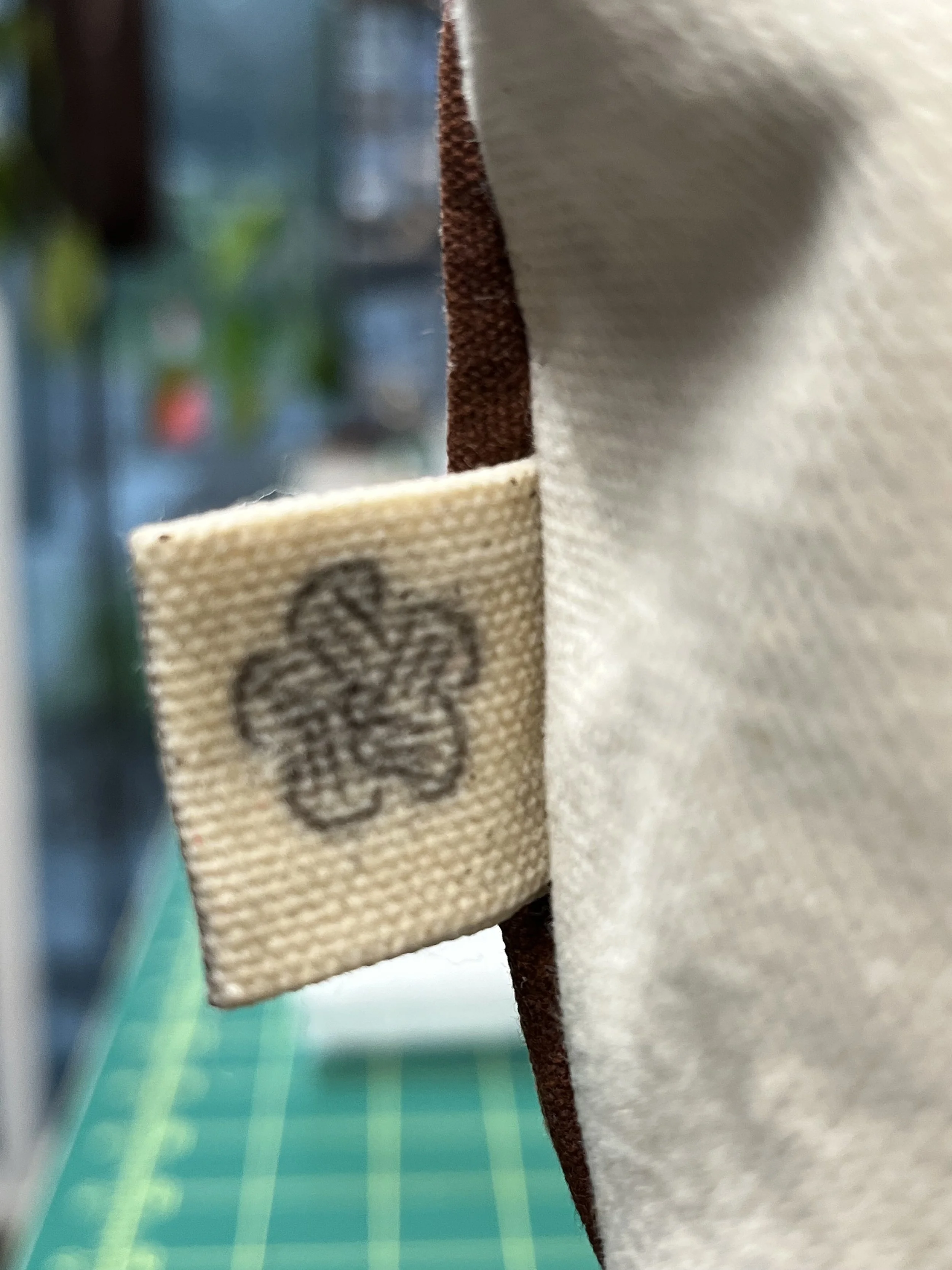 Close-up photo of layered fabric with a brown, beige, and white color palette, and visible textured details.