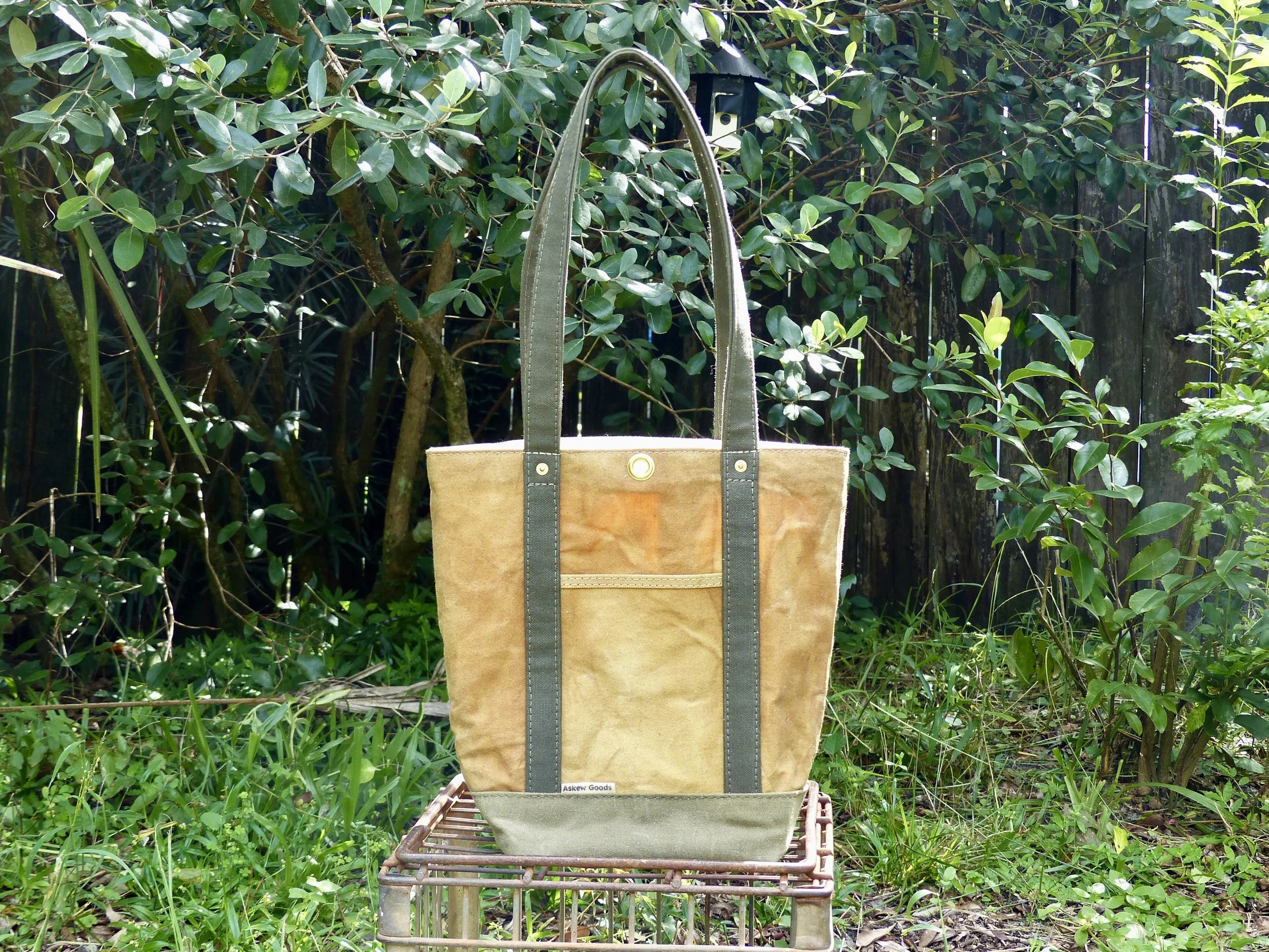 Hand-dyed with onion skins then waxed, olive straps and base.