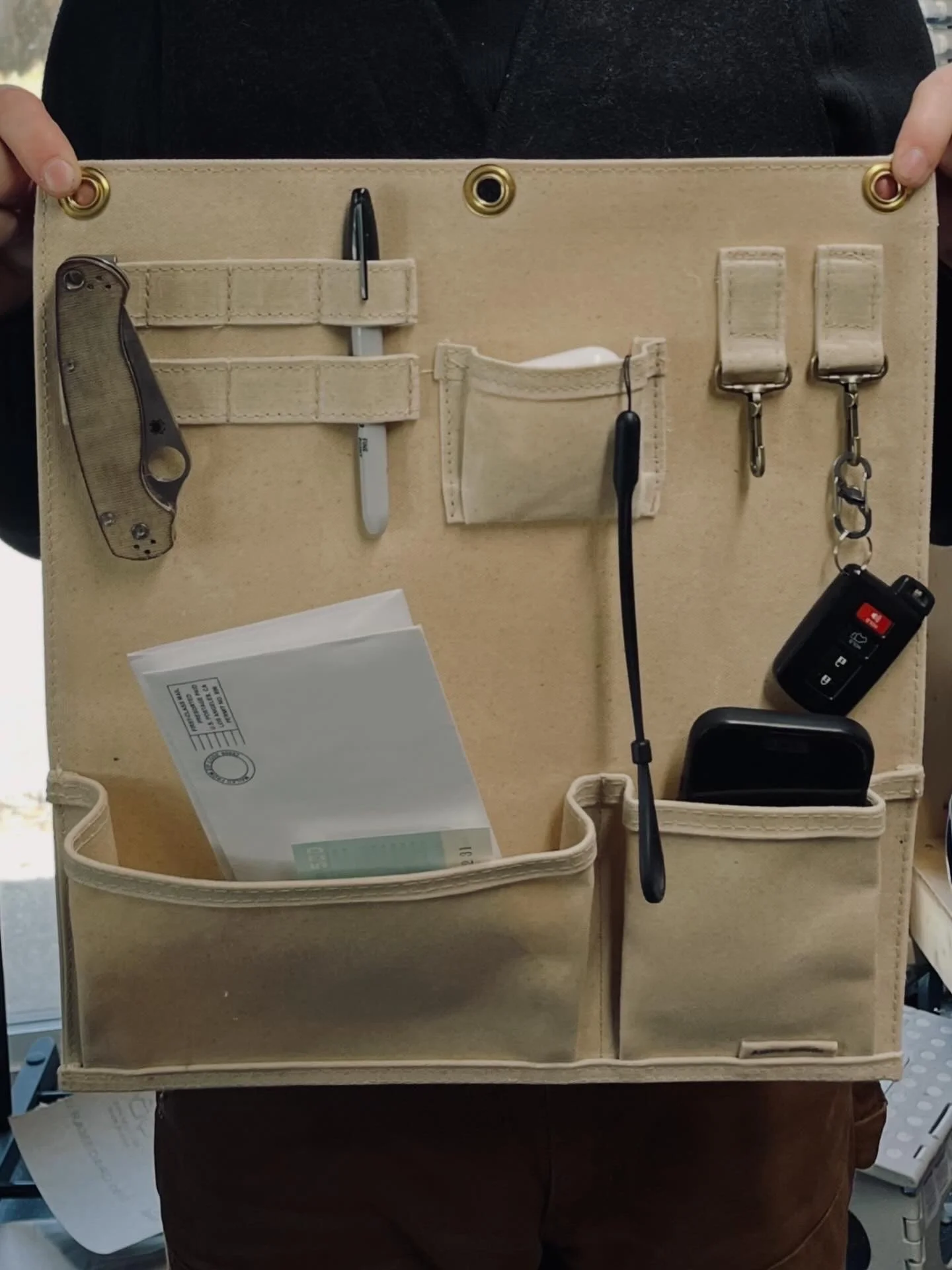 Waxed canvas wall organizer. Hang it on your wall to easily house your keys, phone, and whatever else you need to grab going and coming.