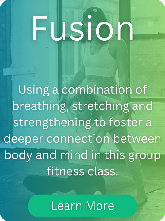 A woman sitting cross legged on the ground sitting straight up with her hands behind her head.  Another woman is standing behind her holding her elbows to maintain her posture.