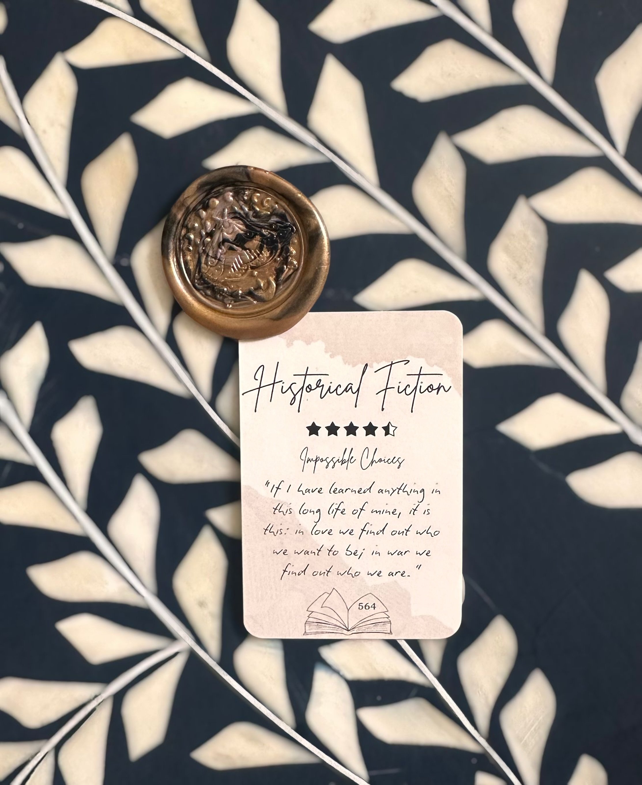 A Blind Date with a Book Bundle featuring a surprise book wrapped in brown paper with a hint card. Includes bookmarks, stickers, annotating strips, wax seal, and more.