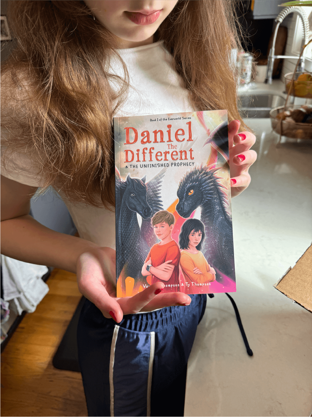 Close up photo of girl holding Daniel the Different book