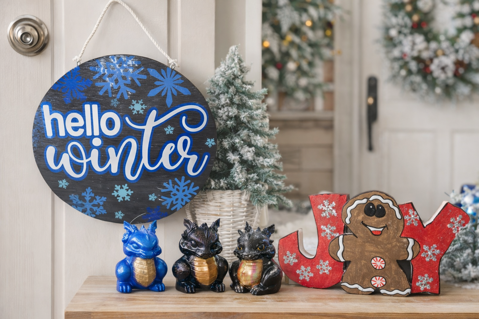 Handmade wooden and epoxy home decor including winter door hanger and resin shelf sitters styled in an entryway