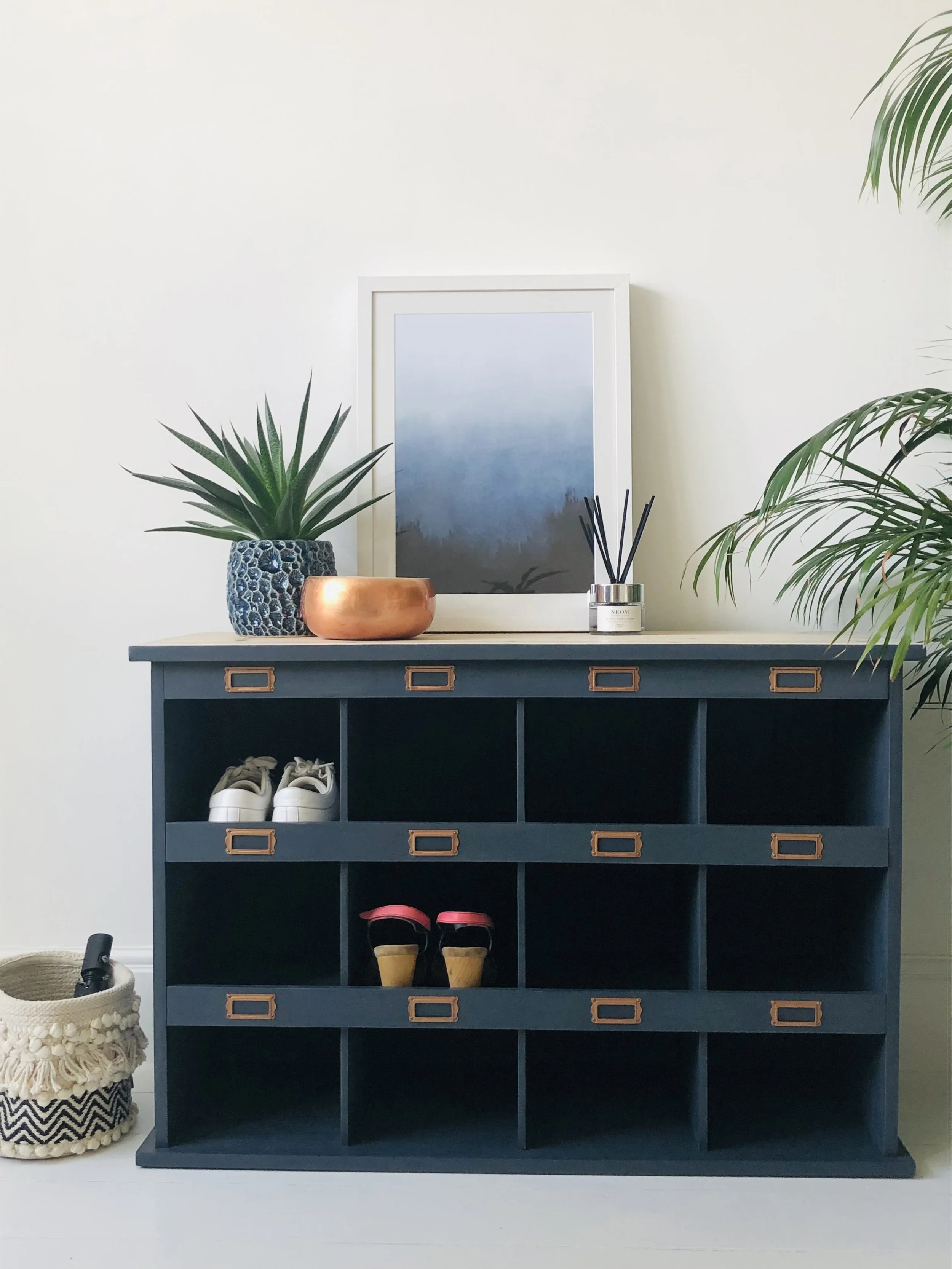Upcycled shoe cubby painted in dark blue