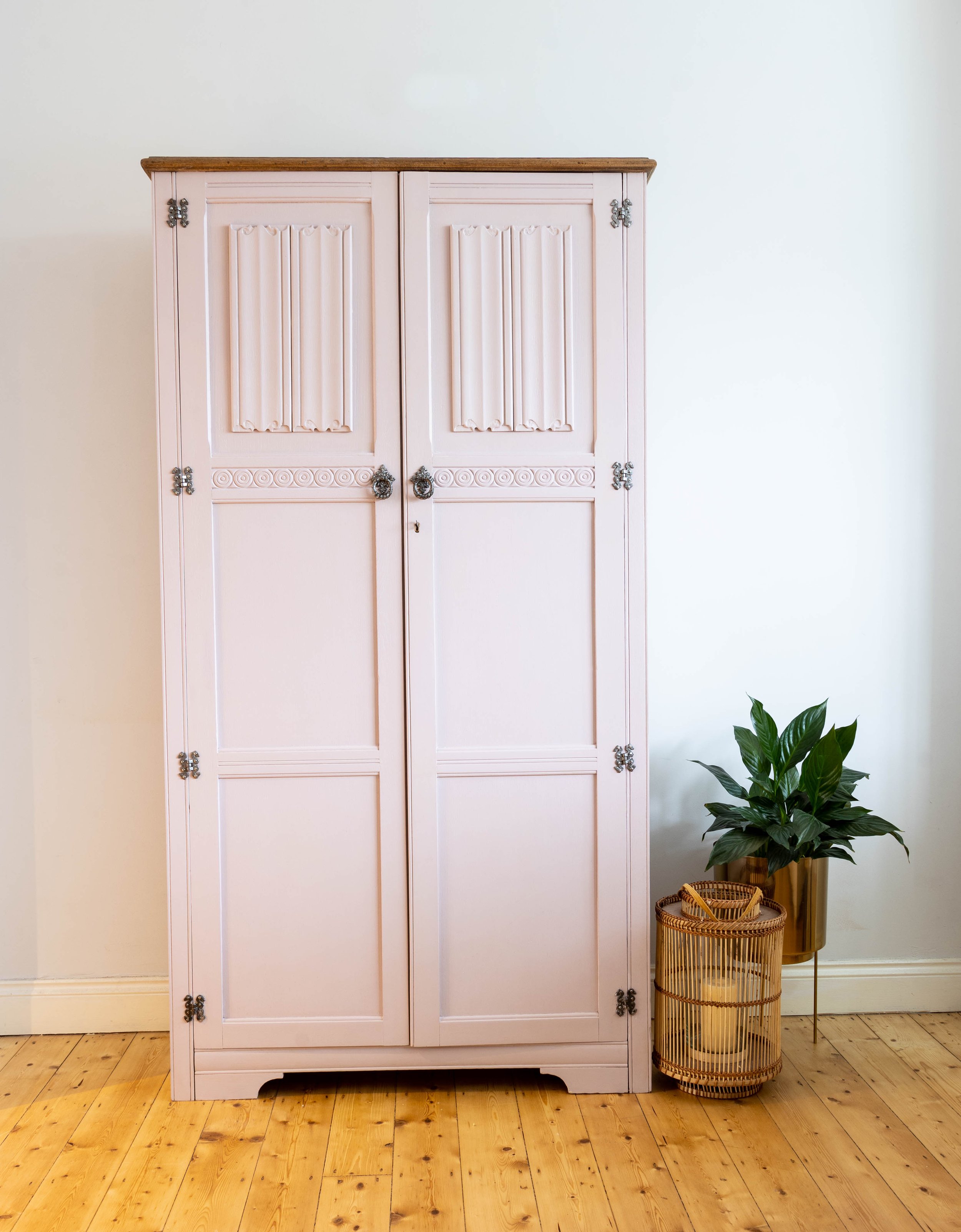 Tall narrow bookcase upcycled into a larder cupboard painted in soft pink