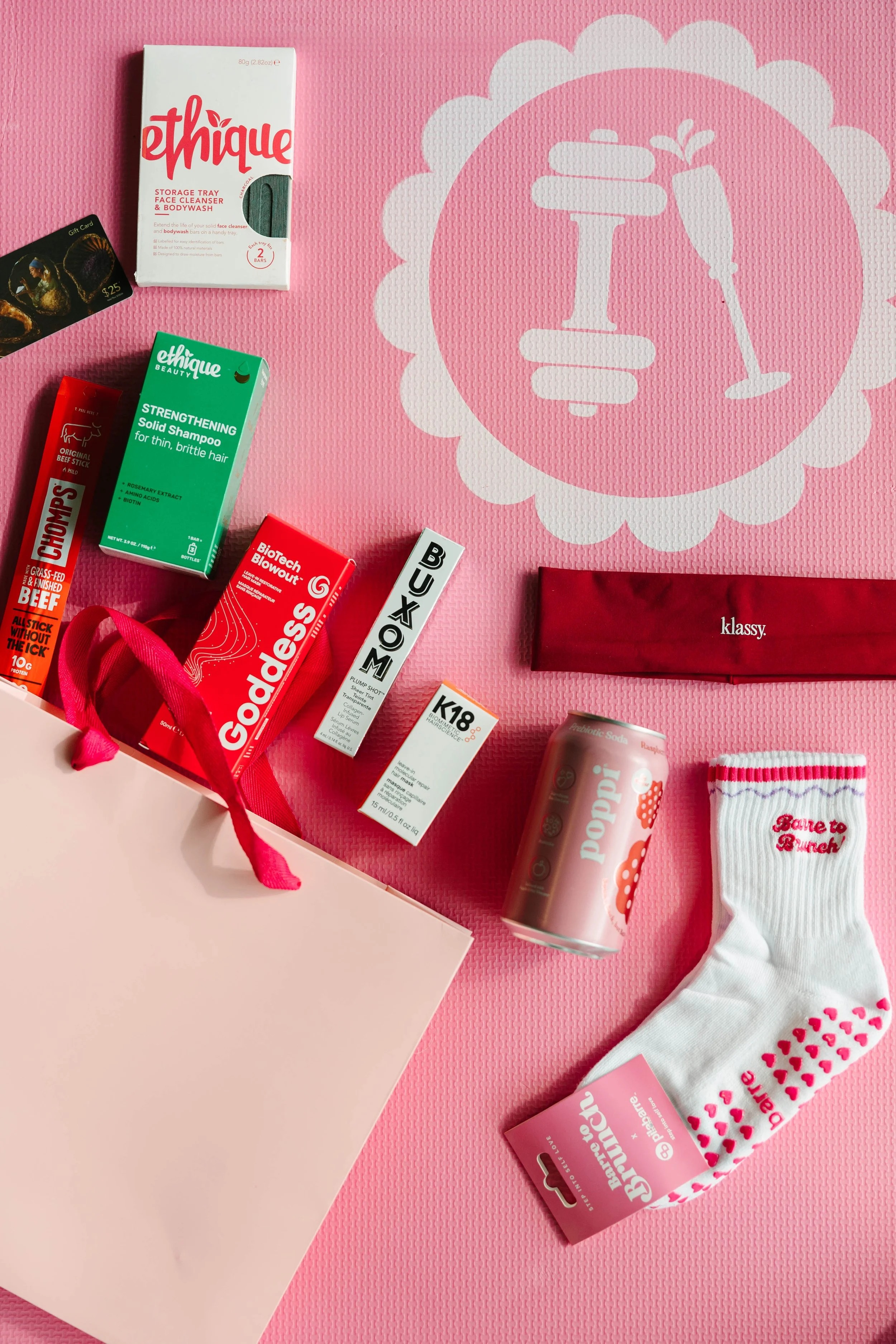 The items include a ethique strengthening shampoo, chomps, Goddess Maintenance, Buxom Lip Gloss, K18 Hair Mask, Poppi, Pilates Socks, Barre to Brunch with Jenna Palek