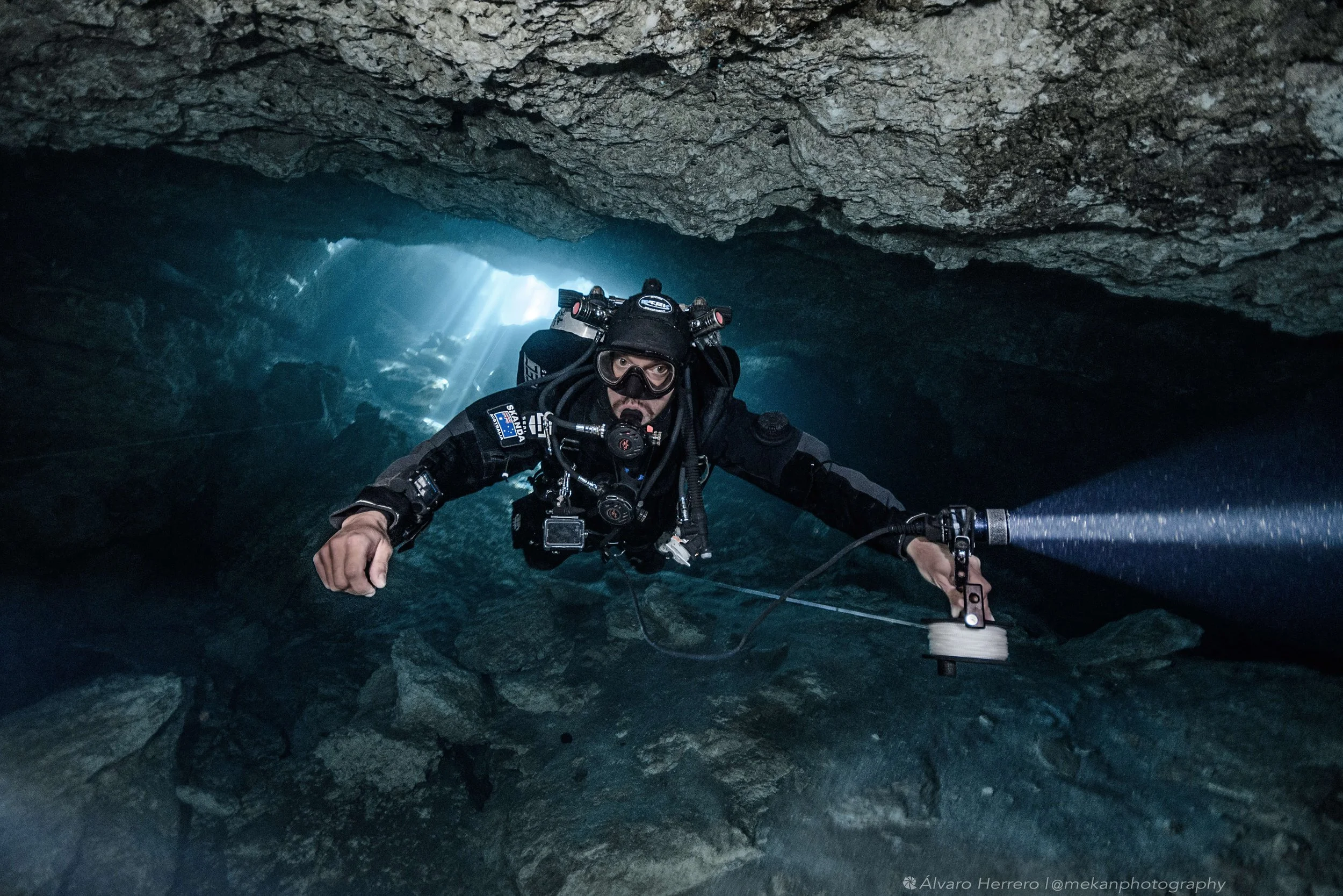 Cave divers learn to run primary reels to connect to fixed cave lines